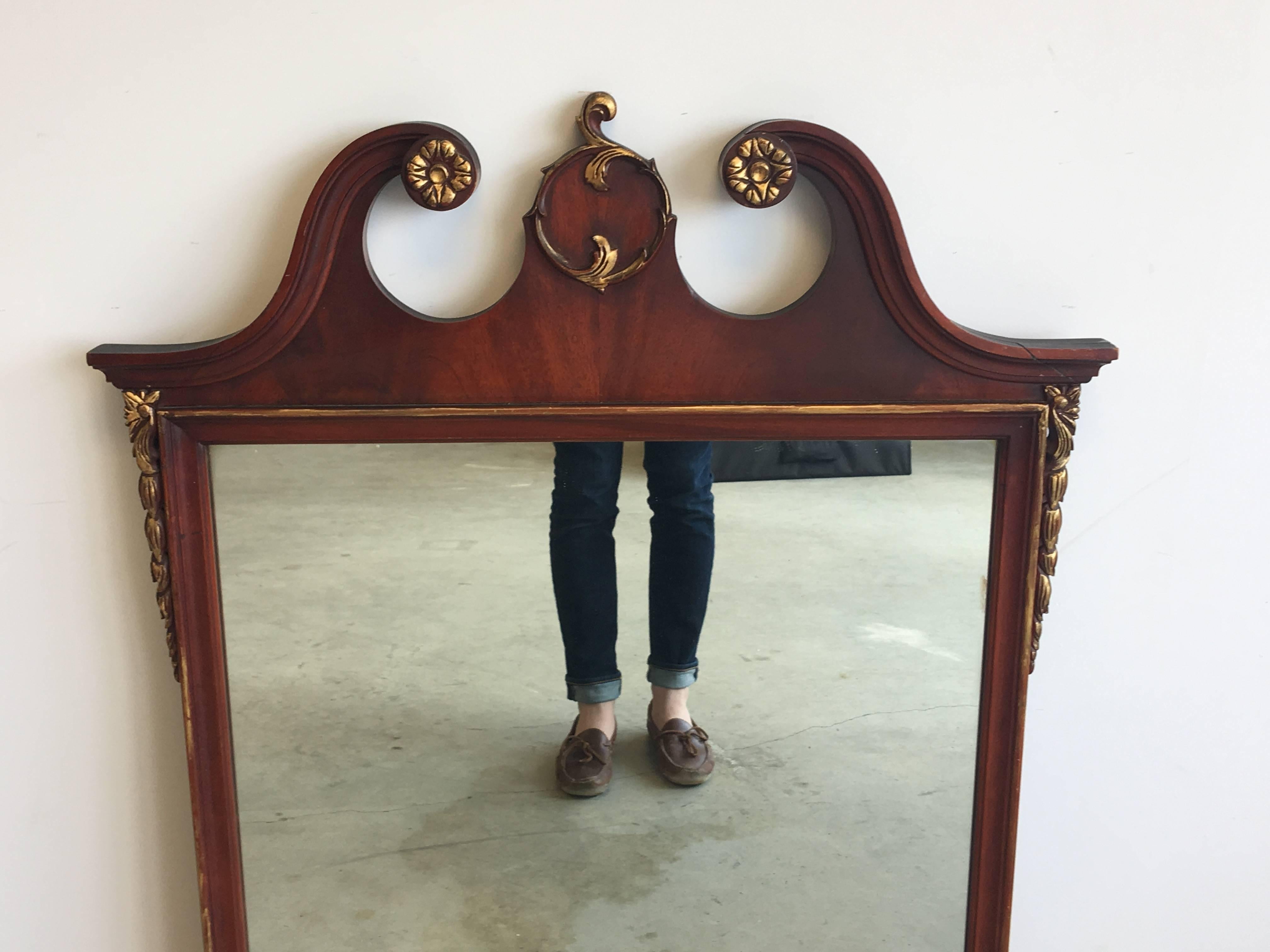 Offered is a gorgeous, 19th century, mahogany and giltwood crest mirror.