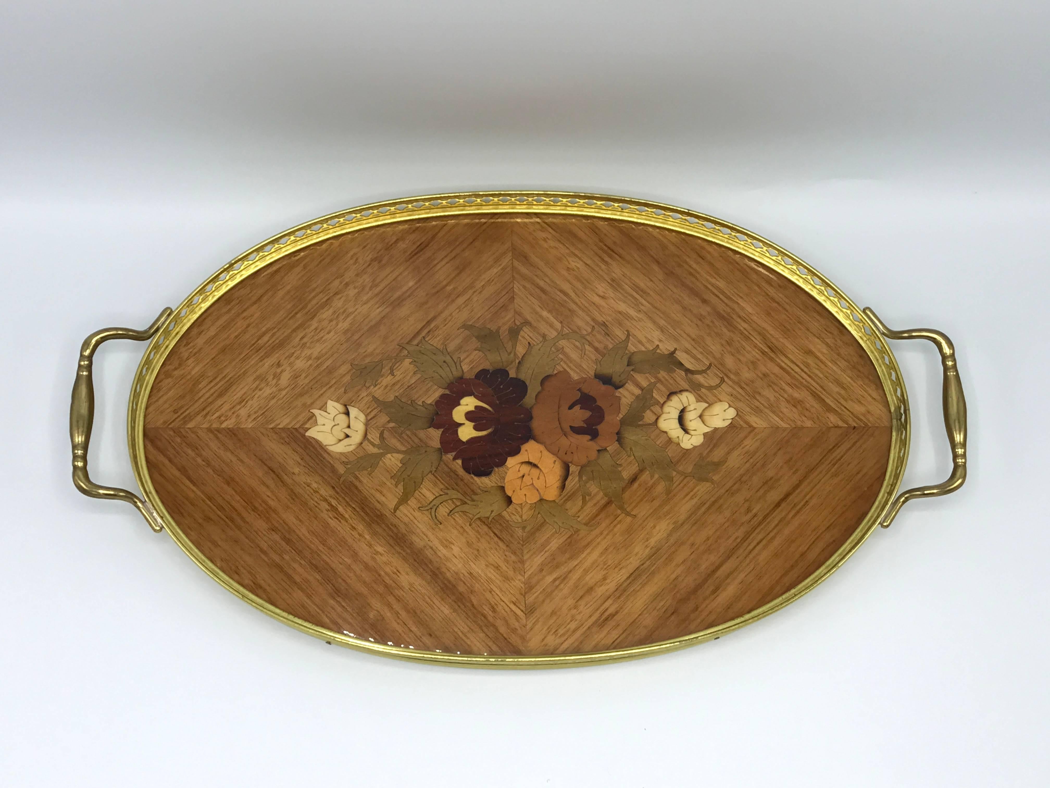Offered is a gorgeous, 1940s Italian inlaid lacquered tray with a floral motif. The piece features a brass trellis border with handles.