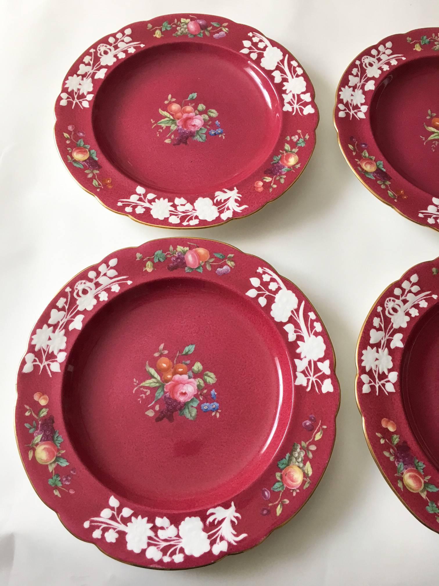 Offered is an exquisite set of six ruby red hand-painted dessert plates, marked in green underglaze by Spode, Copeland's China, England (1891-into the 20th century), with a red over glaze Tiffany & Co. New York mark. Each plate features a
