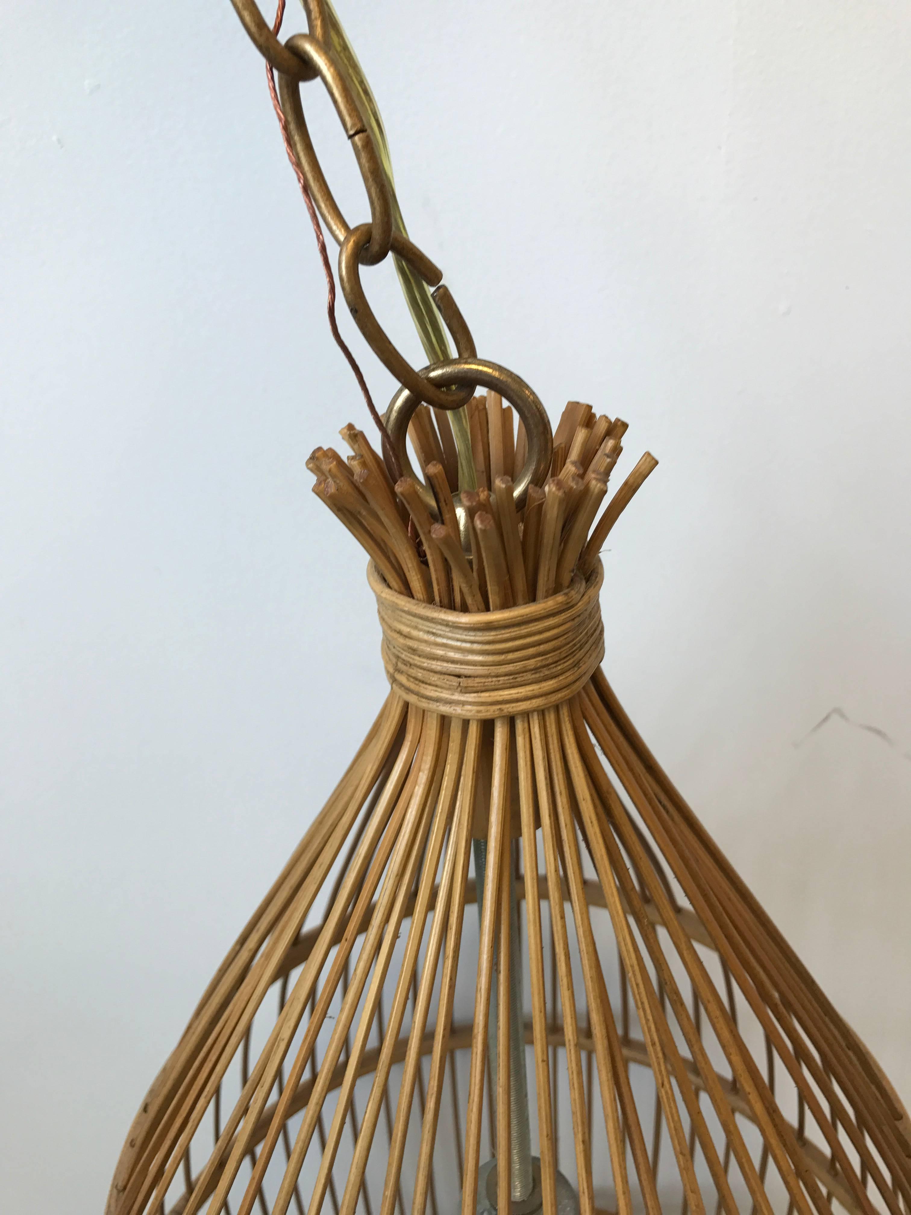 Offered is a gorgeous, 1970s rattan birdcage chandelier. 54