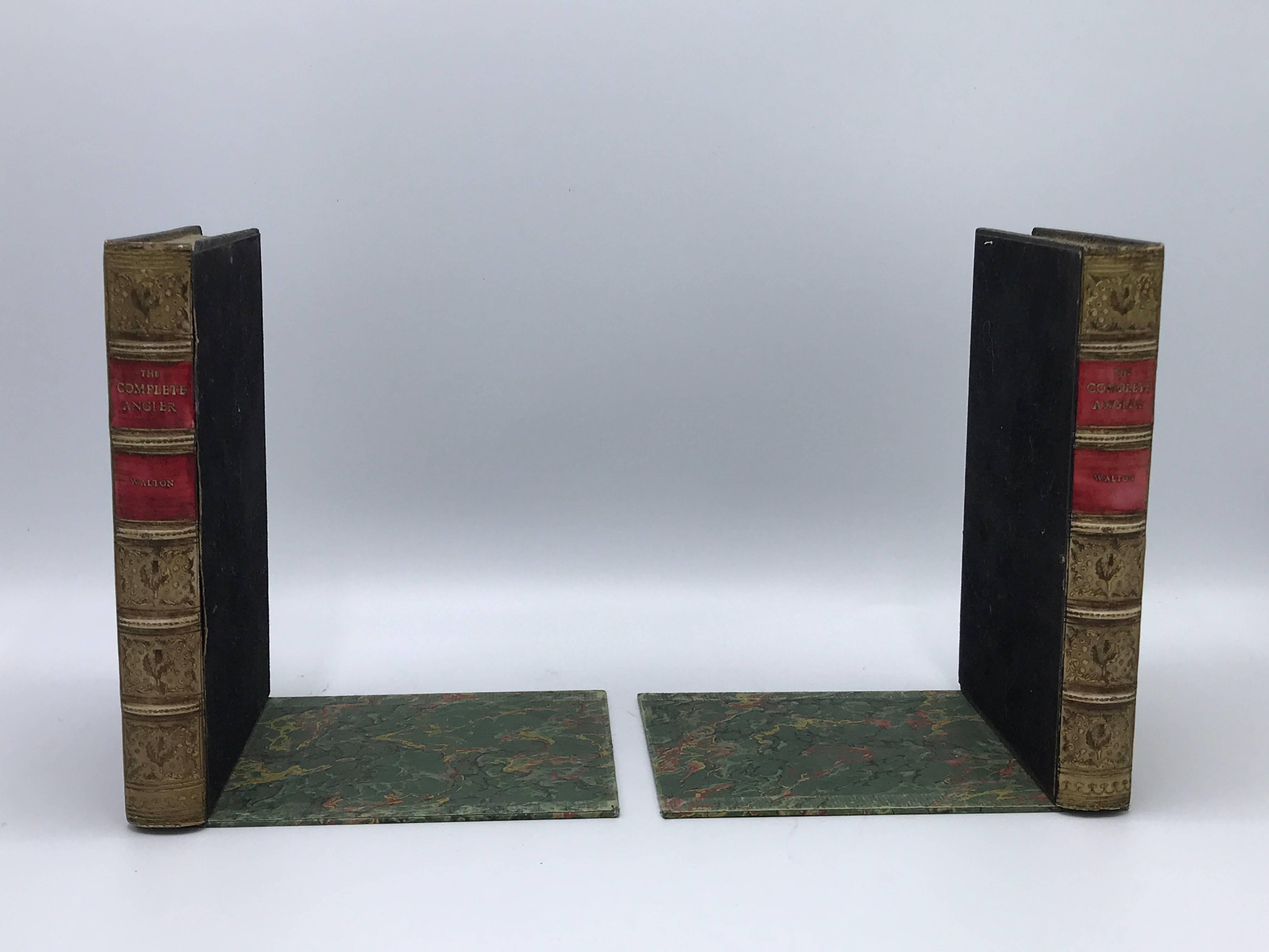 Offered is a stunning pair of 1940s faux leather-resin book sculptural bookends. Metal framing on base and inner book, great for books of all sizes.