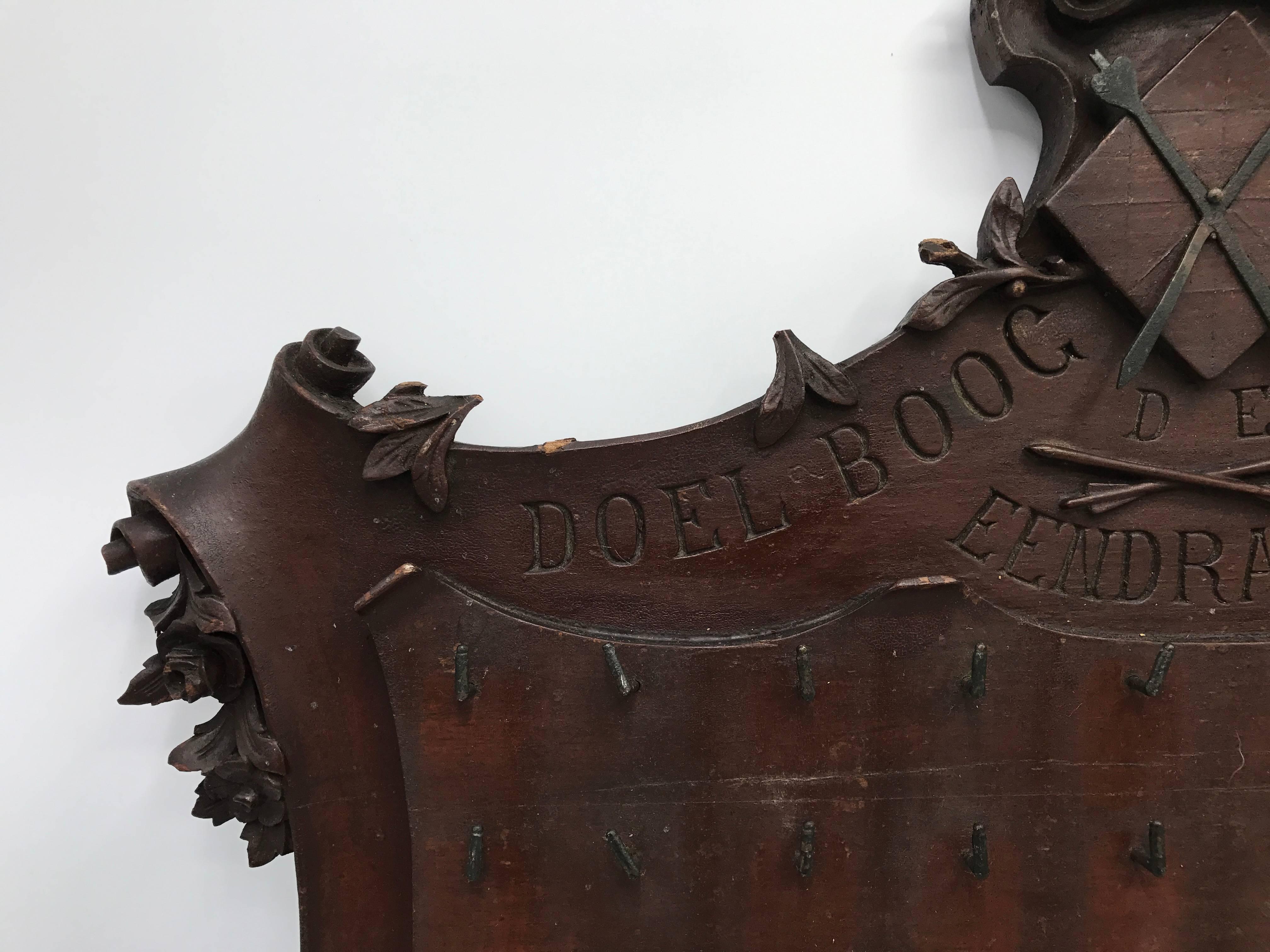 Offered is a gorgeous, 19th century mahogany archery trophy board for plaques. Hand-carved detailing. 50 hooks. Marked: 1894.
