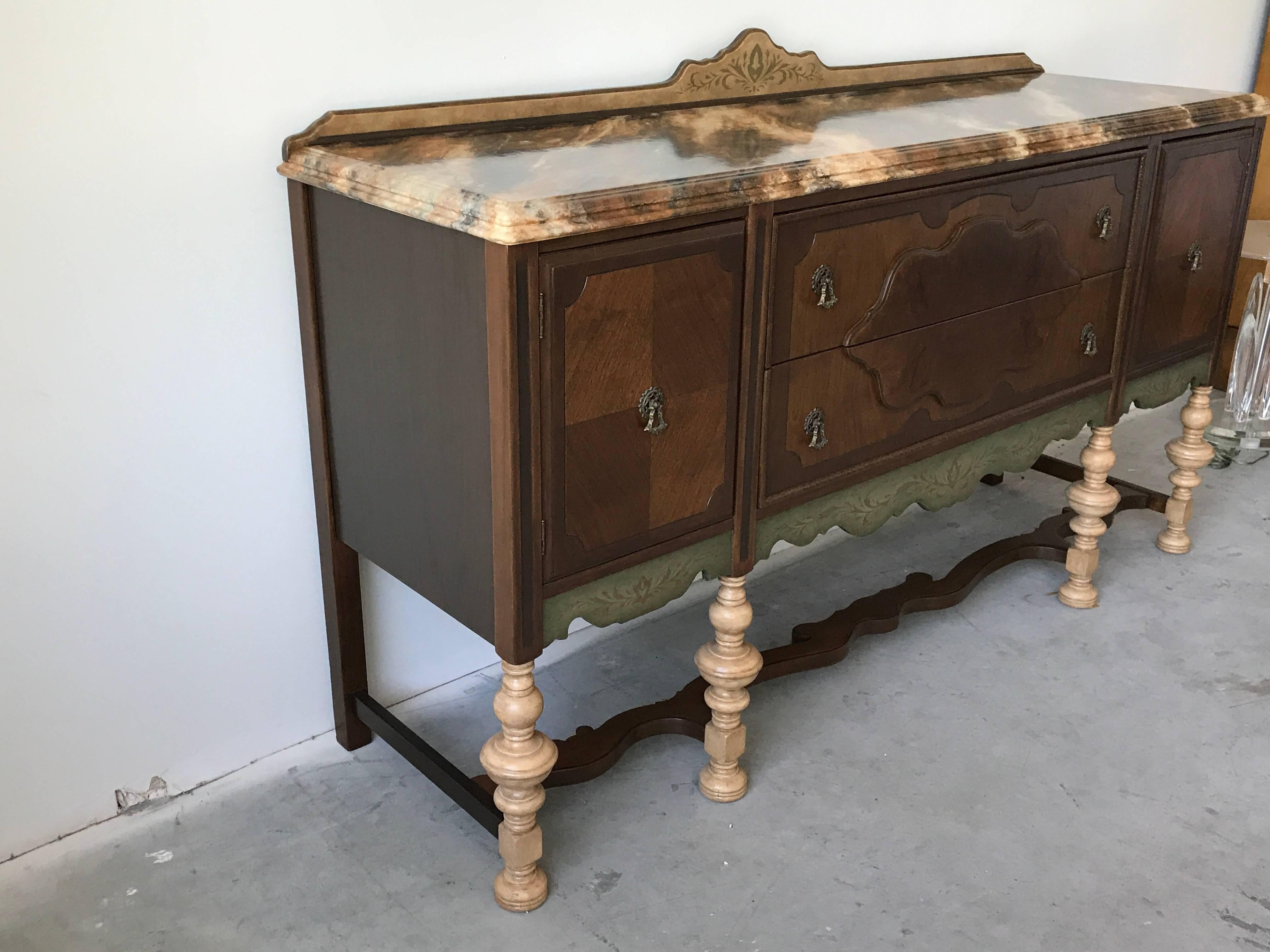 Offered is a stunning, 19th century, oak buffet sideboard. The piece has been completely restored, re-stained, and repainted, complimented by a gorgeous hand painted faux-marble top and hand painted stencil-work. Ample storage, with two large
