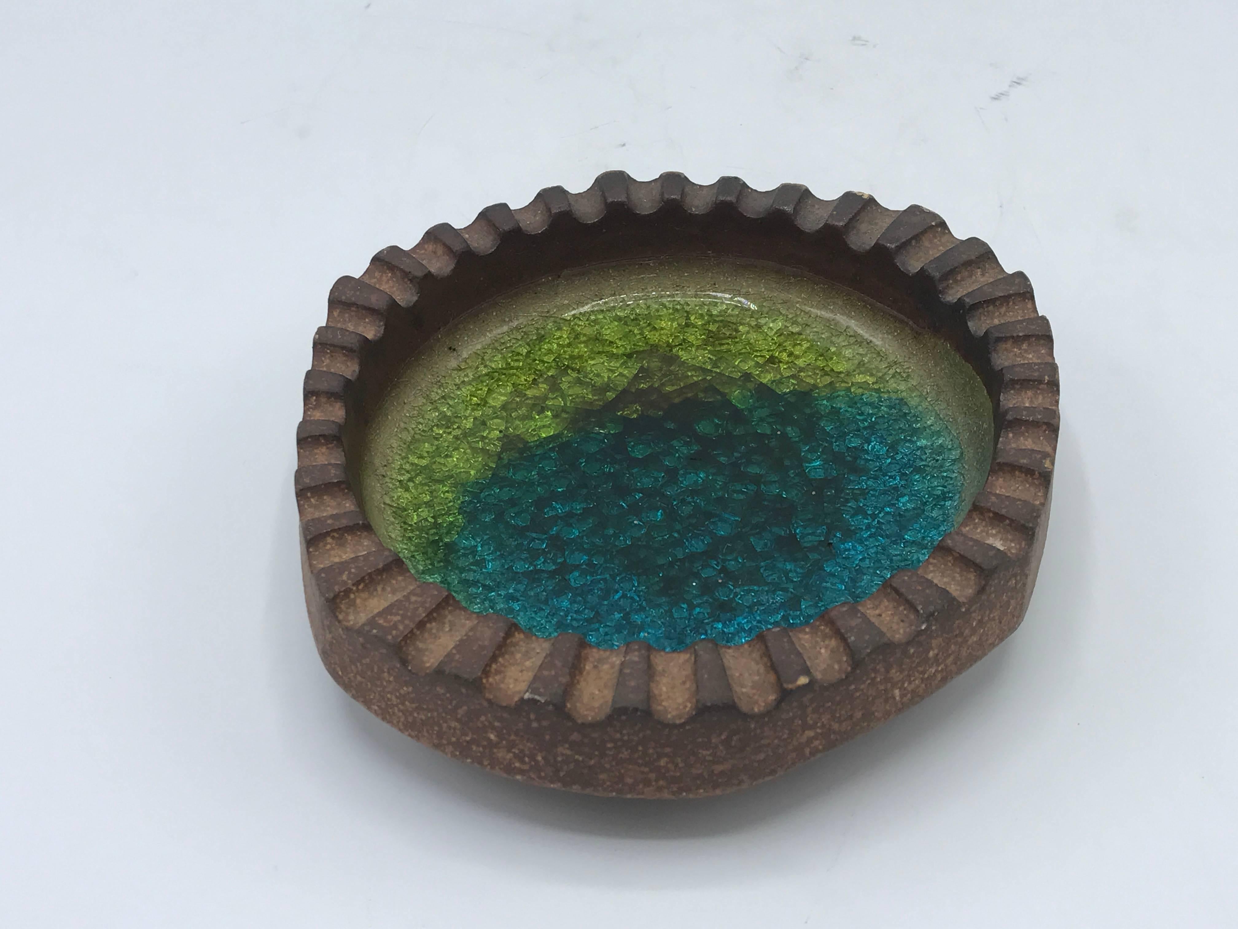 Offered is a stunning, 1970s Robert Maxwell pottery with blue and green glass ashtray catchall dish. Signed on backside.