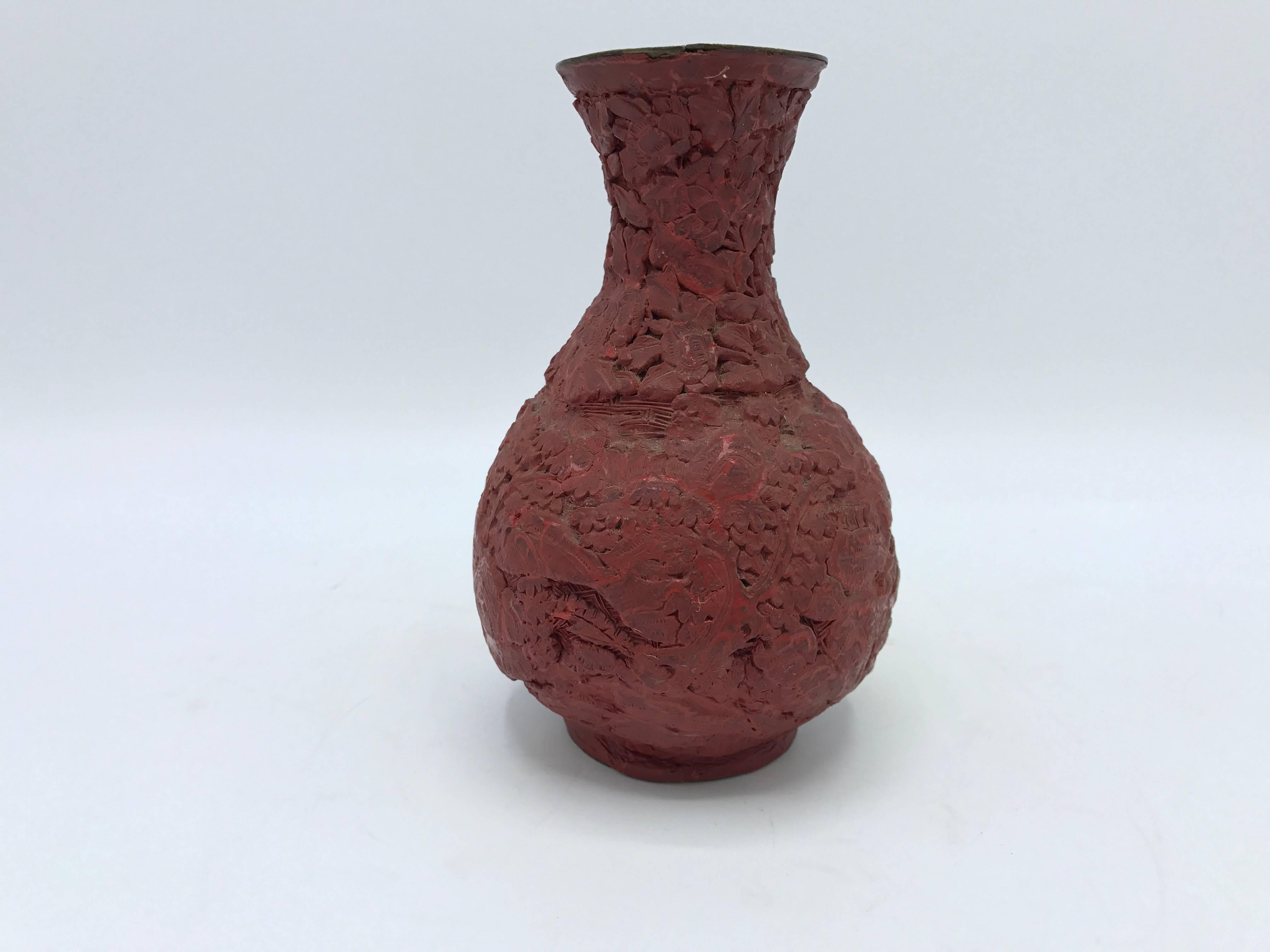 Offered is a gorgeous, 18th-19th century cinnabar vase with a floral motif. The piece is in great condition for its age, with minor wear. The allover design is slightly faint and lacking detail, as expected with a piece of this era.