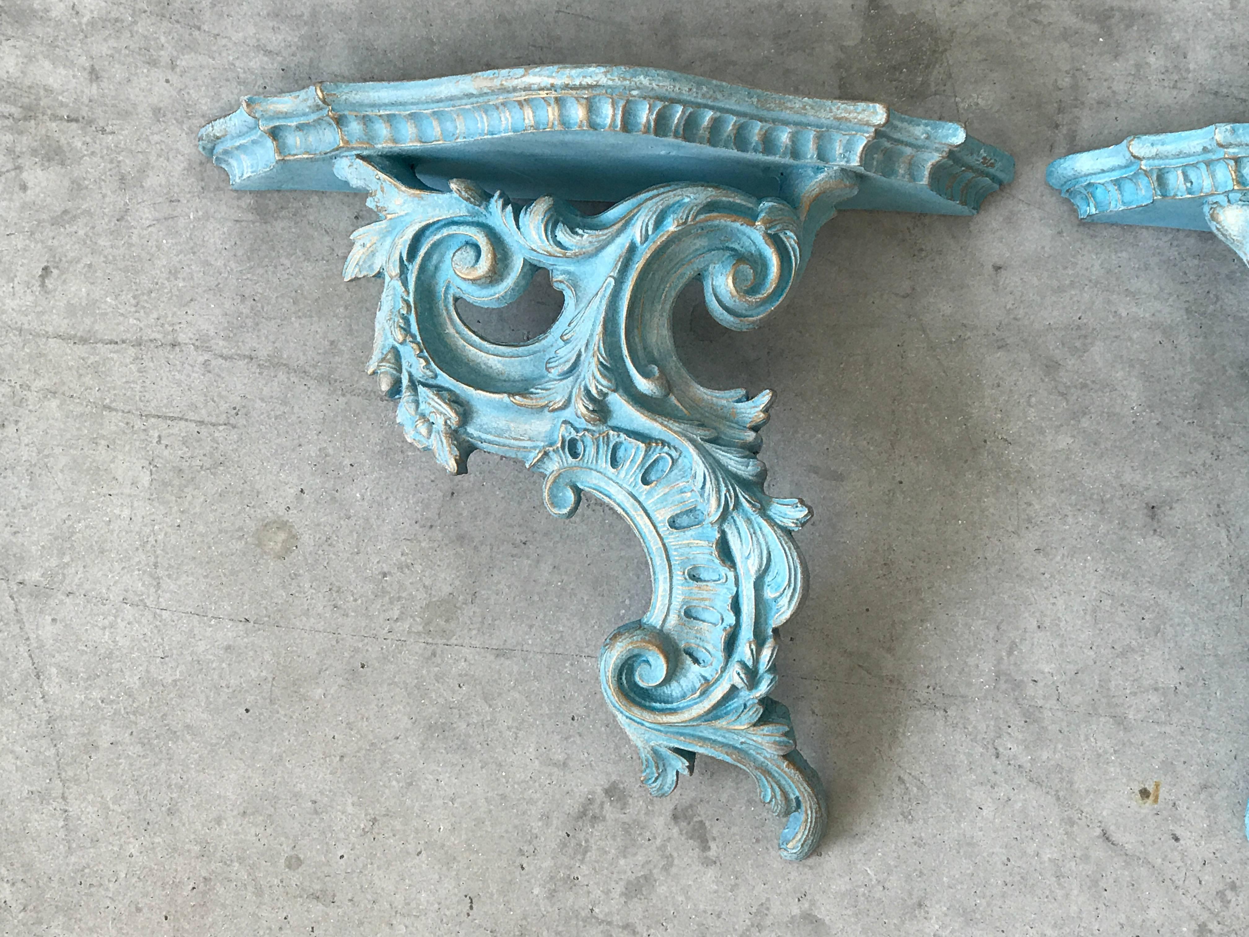 Offered is a gorgeous pair of 1980s hand-painted blue and gold Rococo style wood wall shelves. Fabulous for any Hollywood Regency style home.