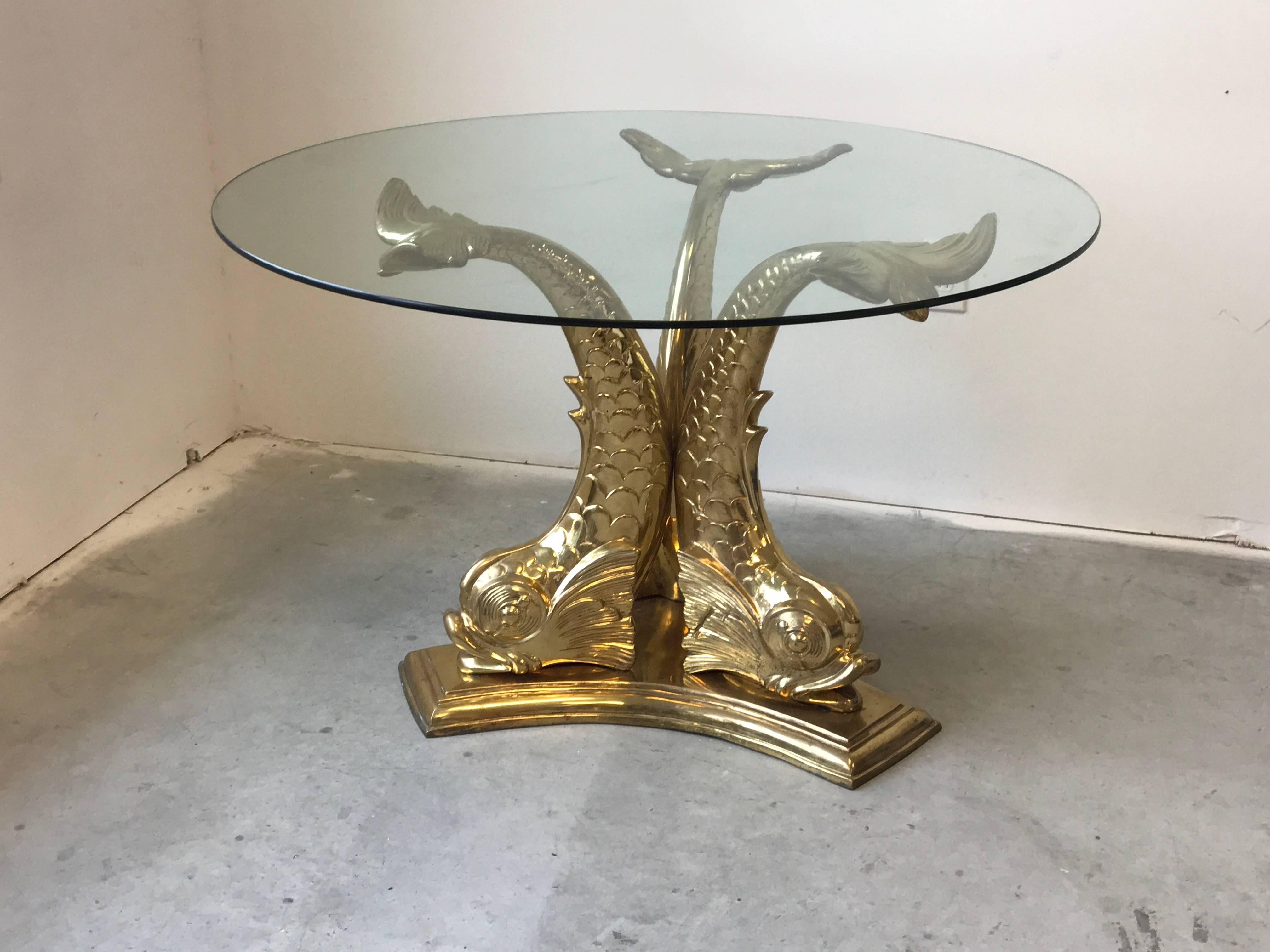 Offered is a fabulous, 1960s Italian brass koi fish dining table with glass top. The piece would make a great entry or foyer table. Can hold a minimum glass top of 36" diameter.