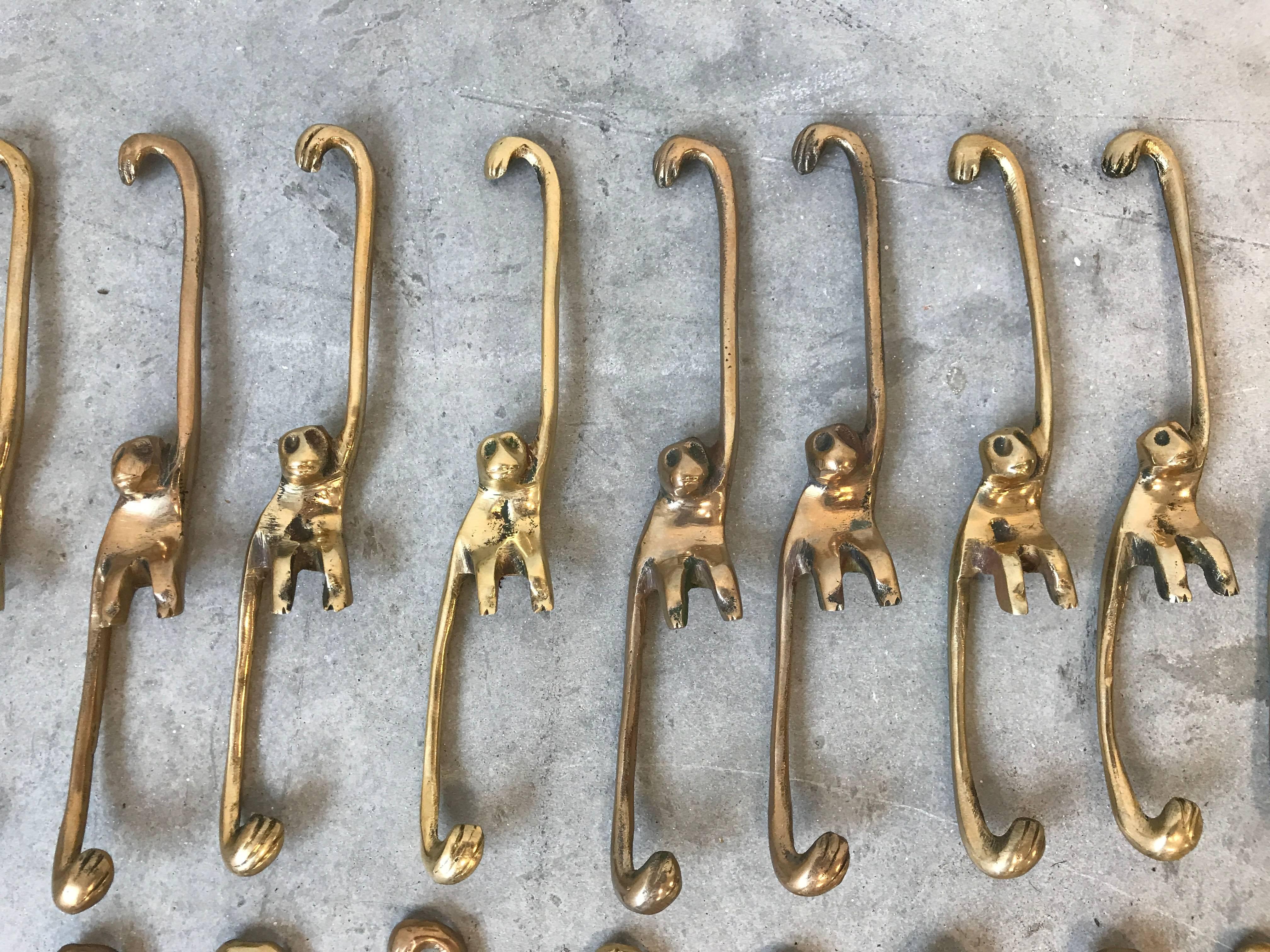 Offered is a fabulous, set of 24, 1960s solid-brass hanging 'Barrel of Monkeys' game. Also great as decorative hangers for plants, etc.