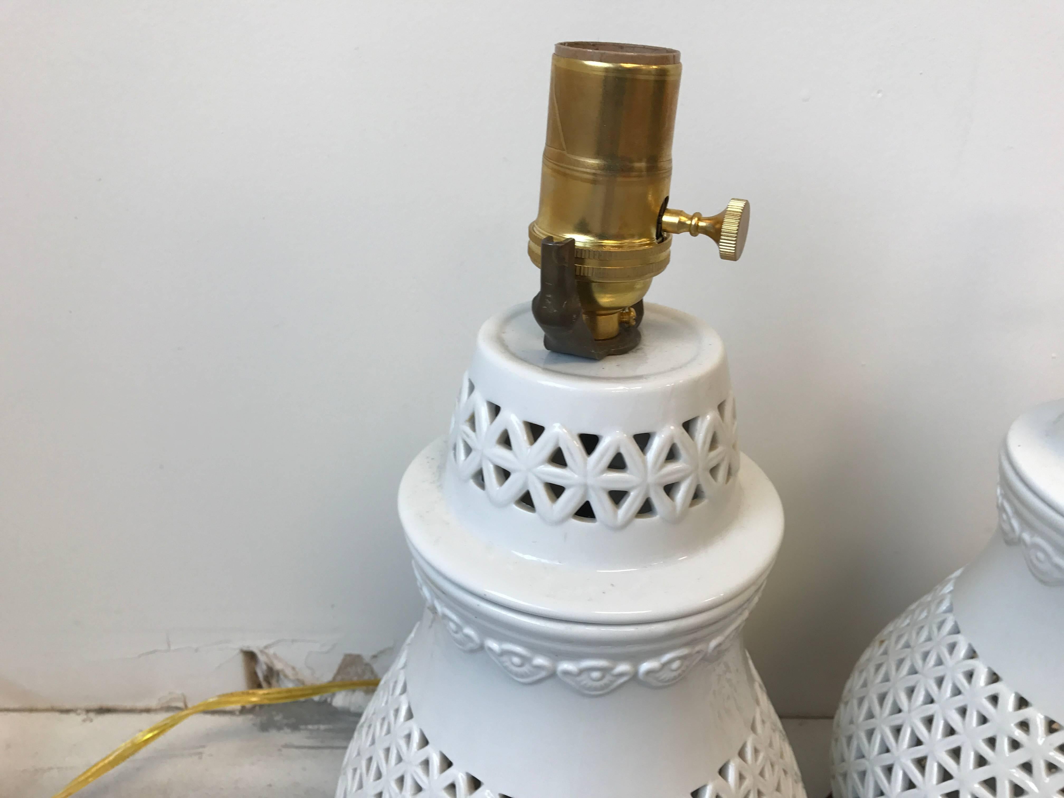 Offered is a stunning, pair of 1960s Blanc de Chine cherry blossom motif lamps. New brass sockets and wiring. The lamps porcelain bodies are in excellent condition. The bases have minor wear finish, but can easily be repainted. Measures: 14.5