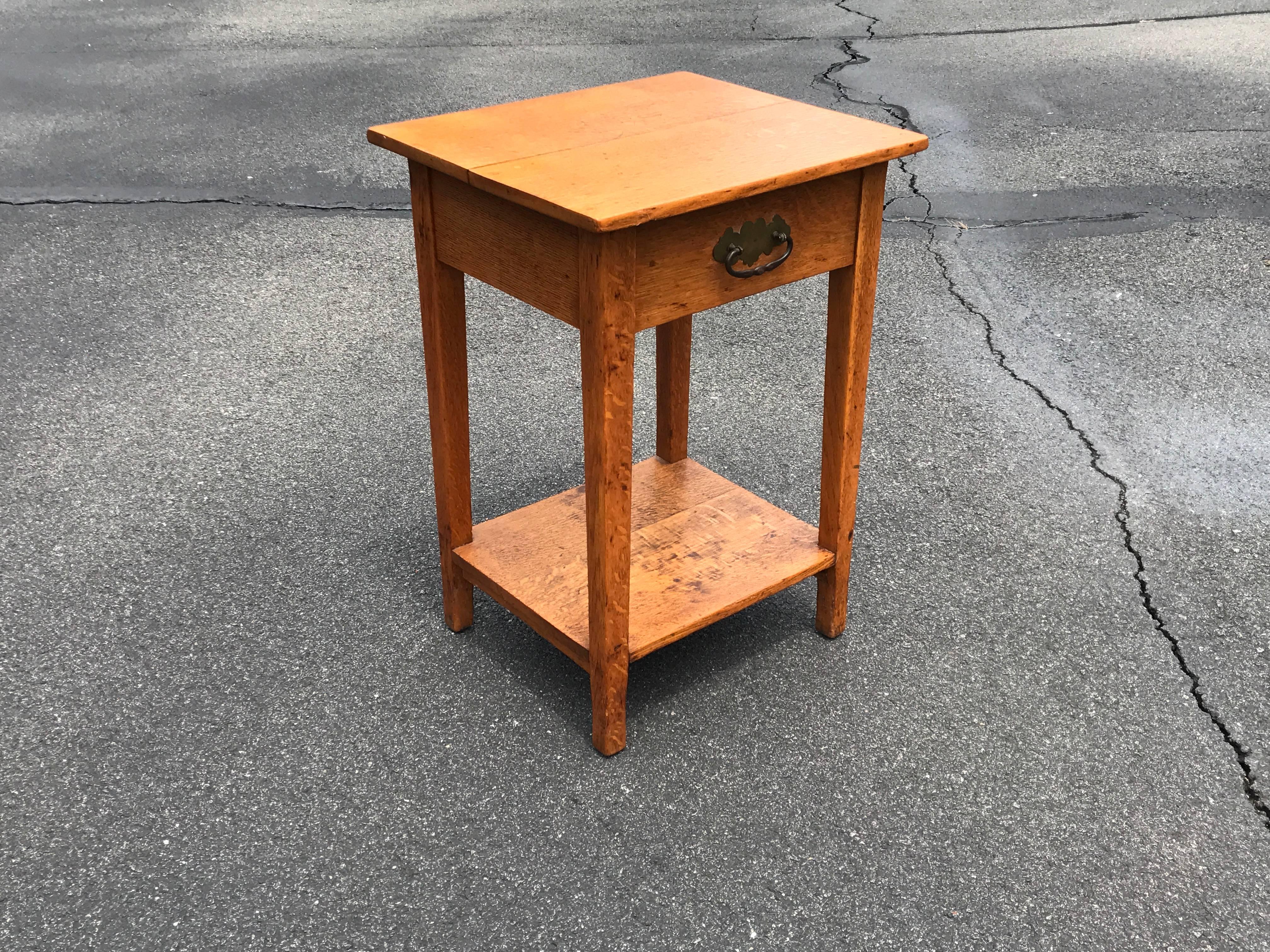 Offered is a gorgeous, 19th century English oak side table with brass hardware.