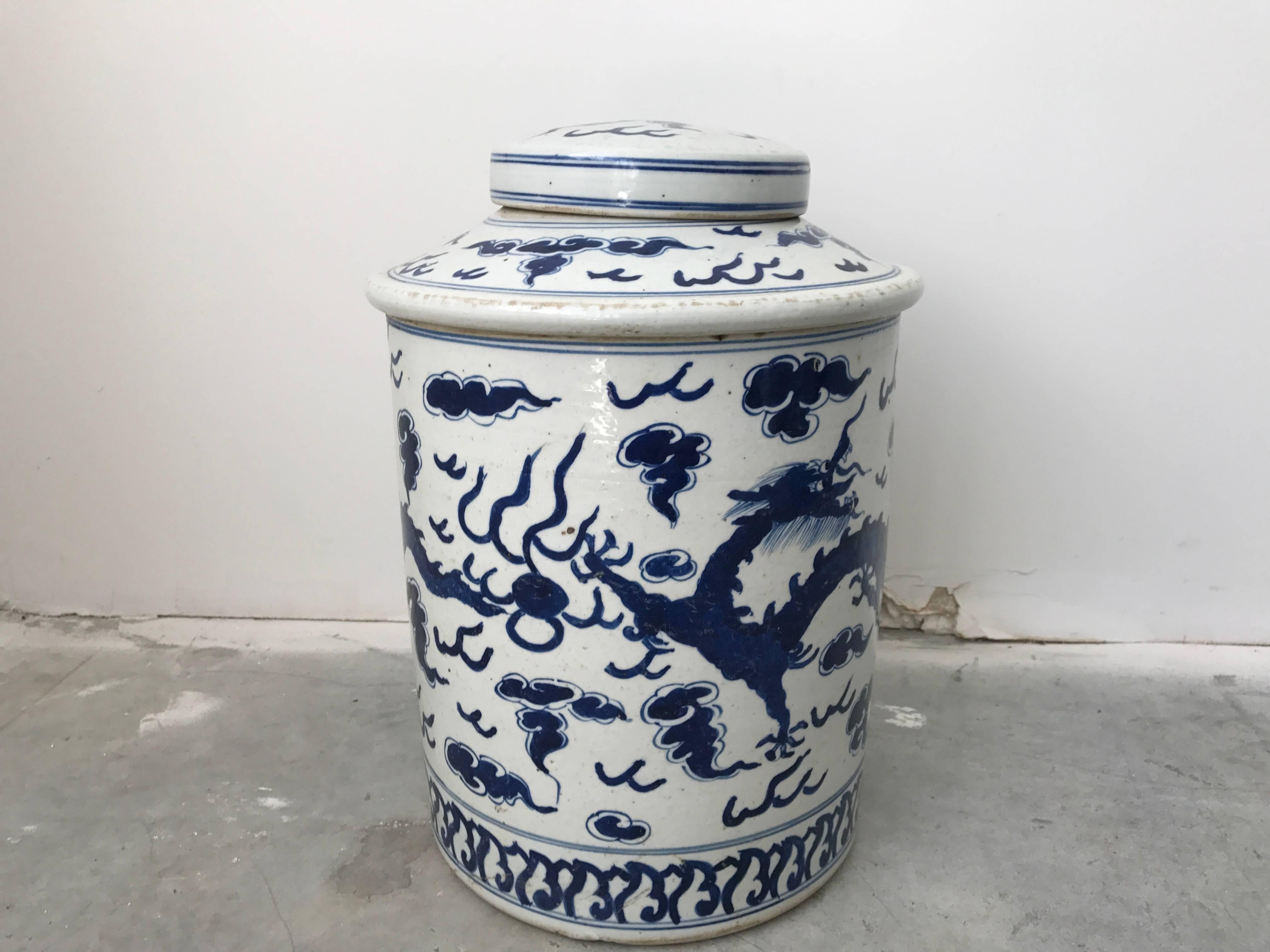 Offered is a gorgeous, large late 19th century blue and white ginger jar urn with a dragon motif on all sides.