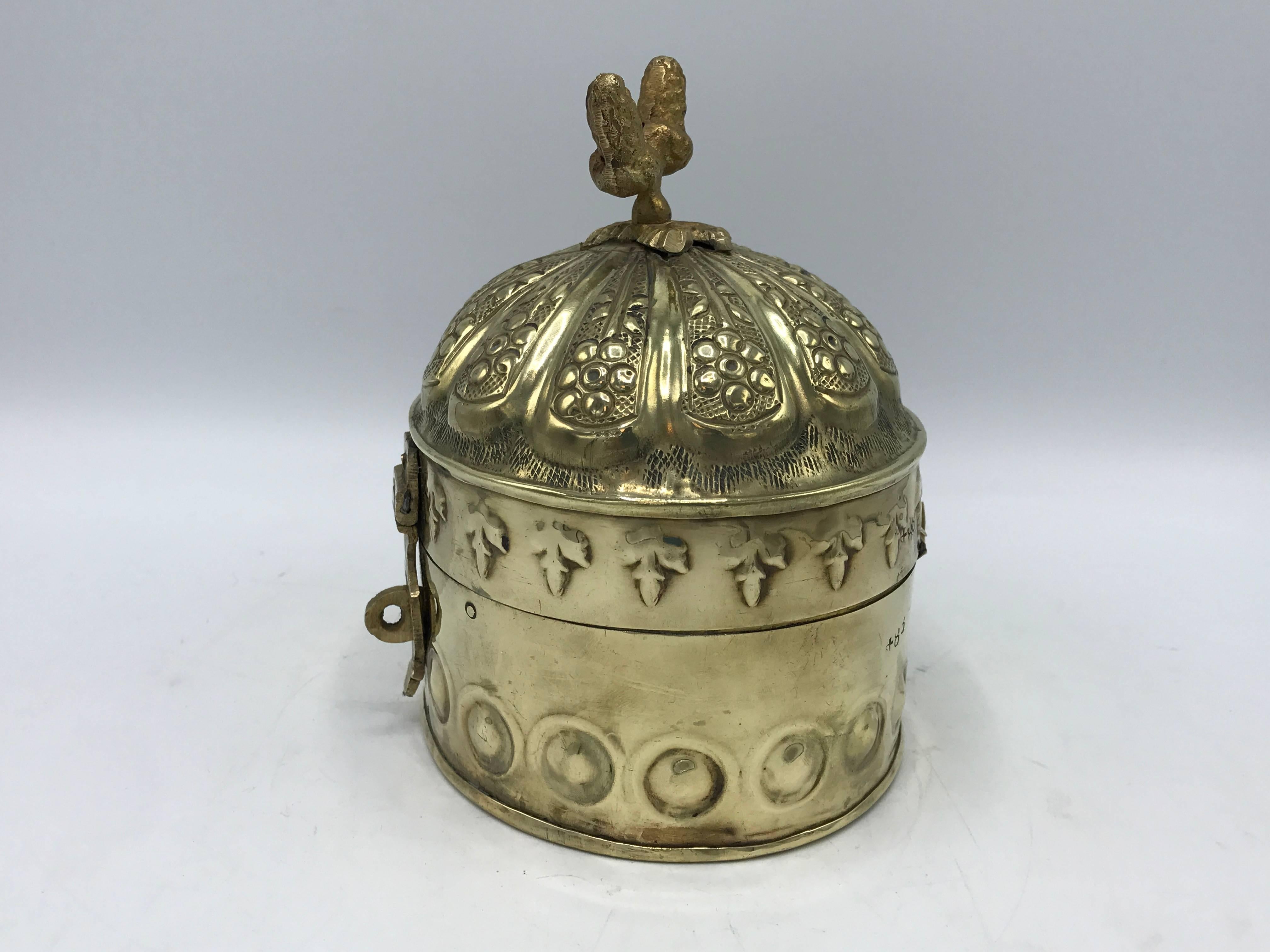 Offered is a gorgeous, 1960s brass lidded-canister with ornate detailing and a finial top. Hinged and clasps.