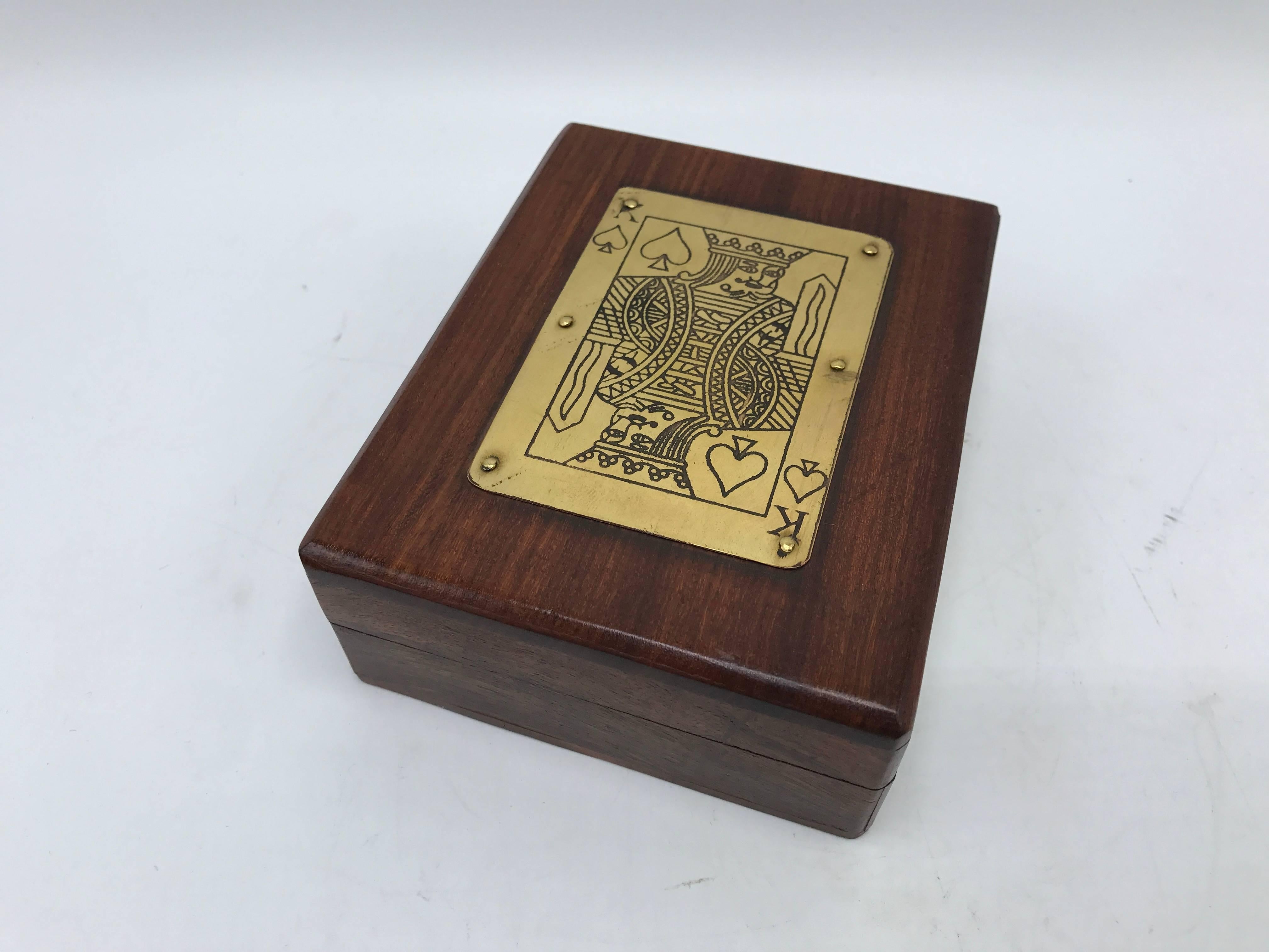 Offered is an exquisite, 1960s, walnut playing card box with a brass 'King of Hearts' plaque. Includes full deck of cards.