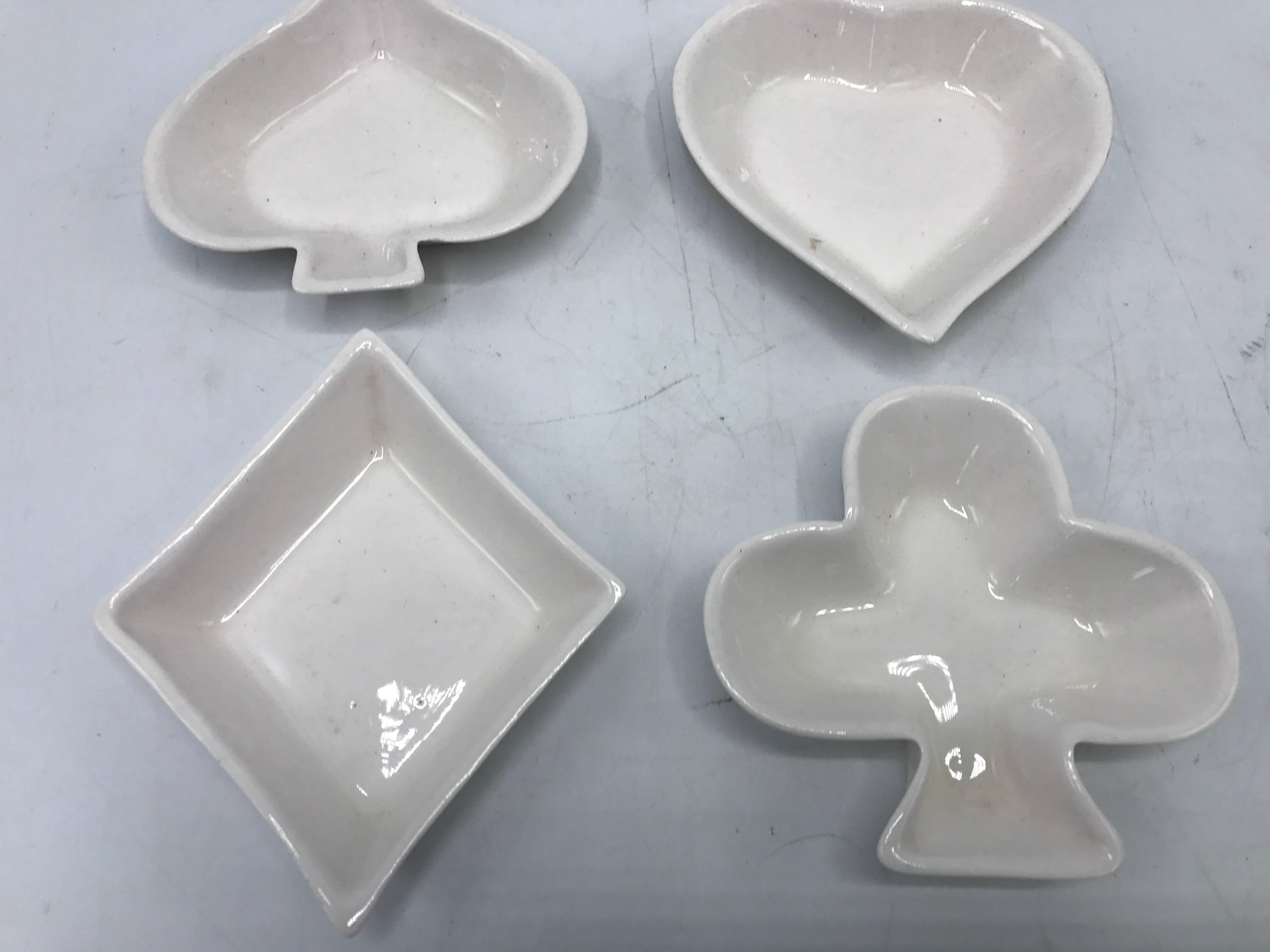 Offered is a gorgeous, set of four, 1960s white porcelain playing card suits decorative dishes. One of each; spade, heart, diamond and club. Marked: Royal Ardalt. Made in England.