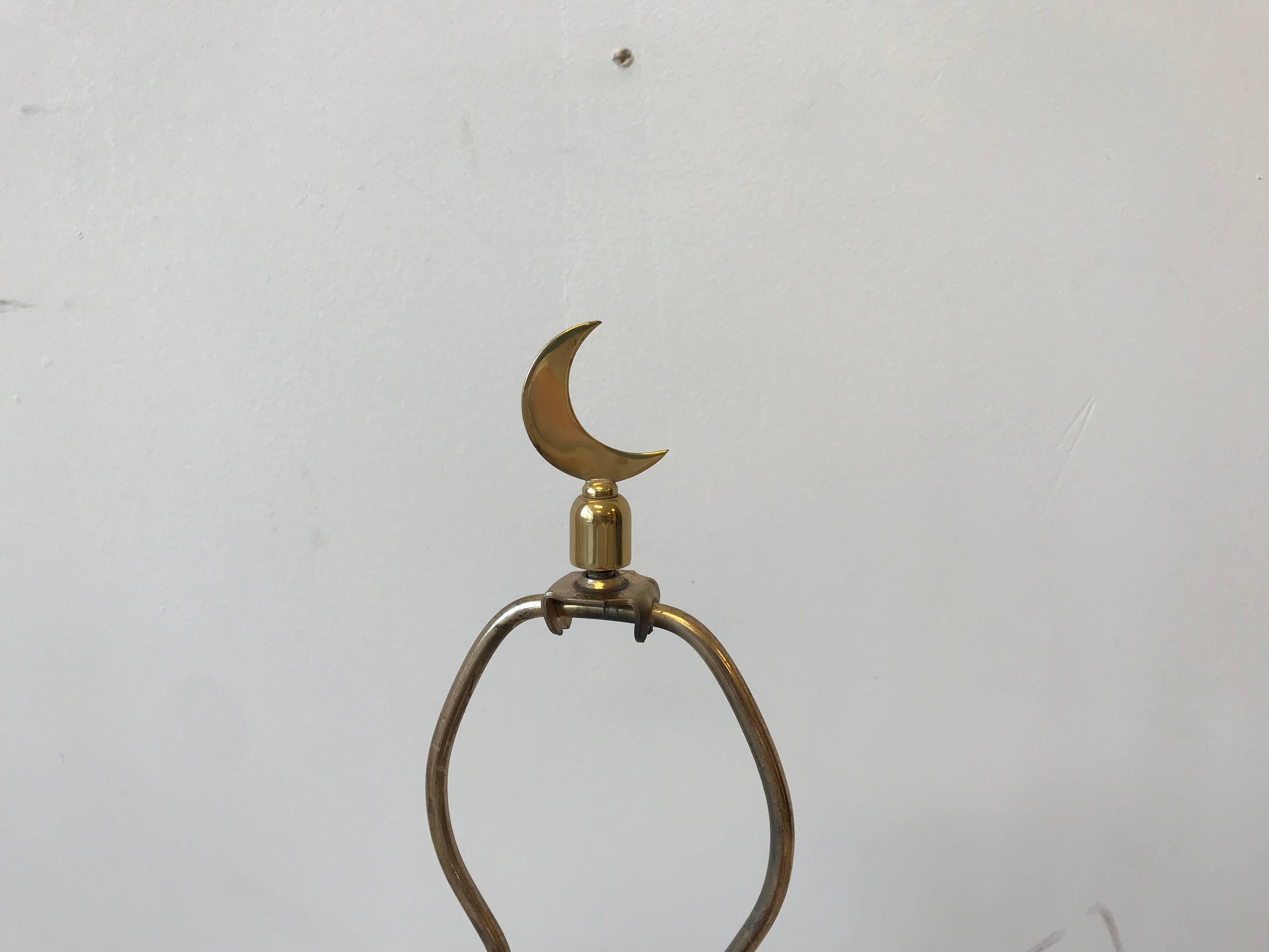 Offered is an exquisite, 1970s Italian brass lamp with a star-shaped base and crescent moon finial. 

Measure: 22.5" from base to socket. US wiring.
