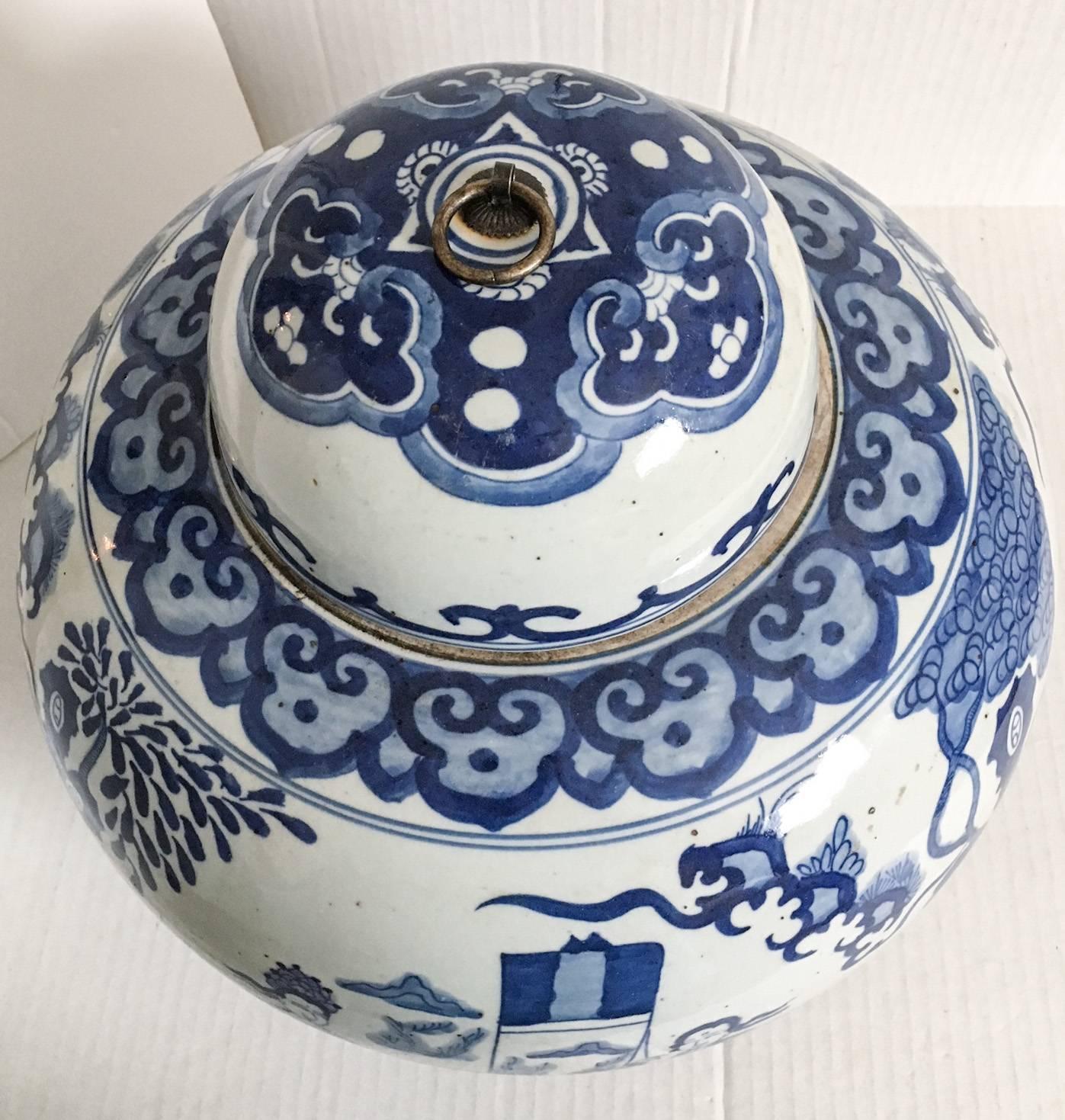 Beyond fabulous large and heavy blue and white Chinese stoneware ginger jar with a metal ring handle on the lid. One of two.