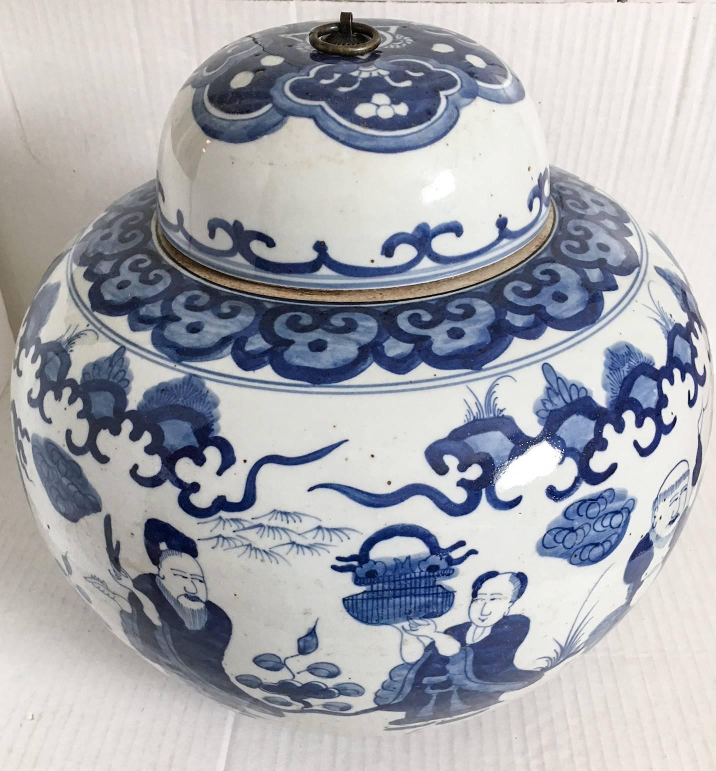 Beyond fabulous large and heavy blue and white Chinese stoneware ginger jar with a metal ring handle on the lid. One of two.