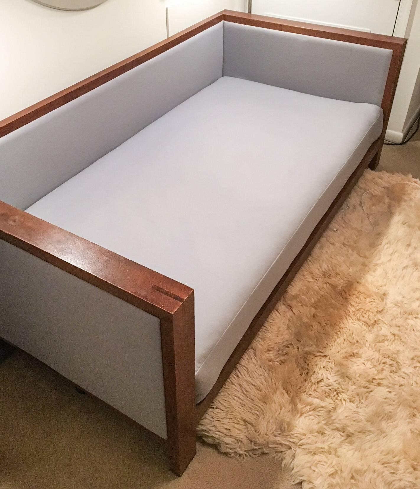 Excellent midcentury style wood frame daybed with new pale blue Hodsoll McKenzie wool billiard cloth upholstery. The cushion is a new twin-sized mattress wrapped in Dacron with a zipper along the back. Back of sofa daybed is has an upholstered panel