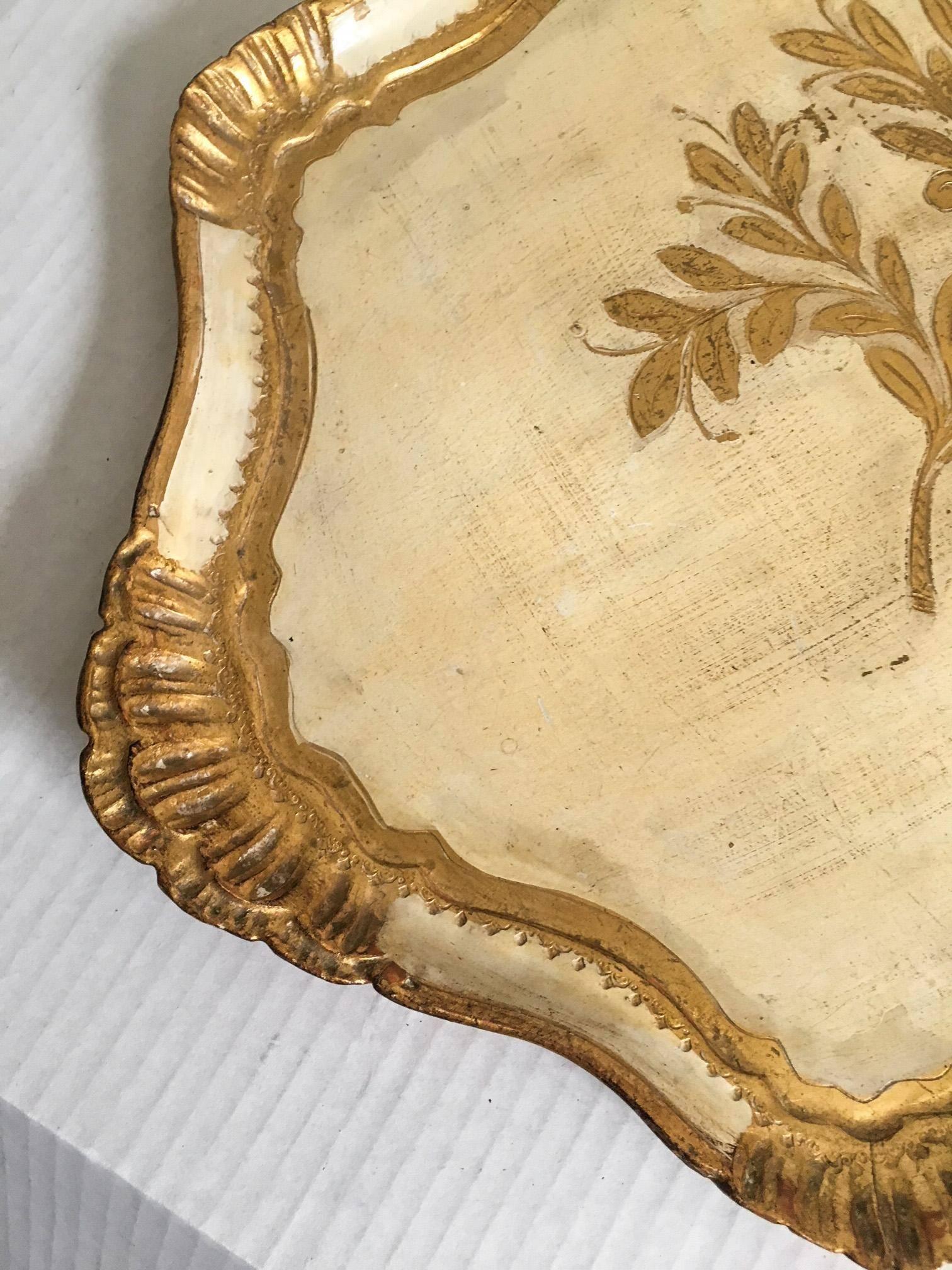 Wonderful Italian Florentine tray made of popular wood and gold leafed and painted. Surface area has some wear and glass rings as pointed out in the photographs. Marked 