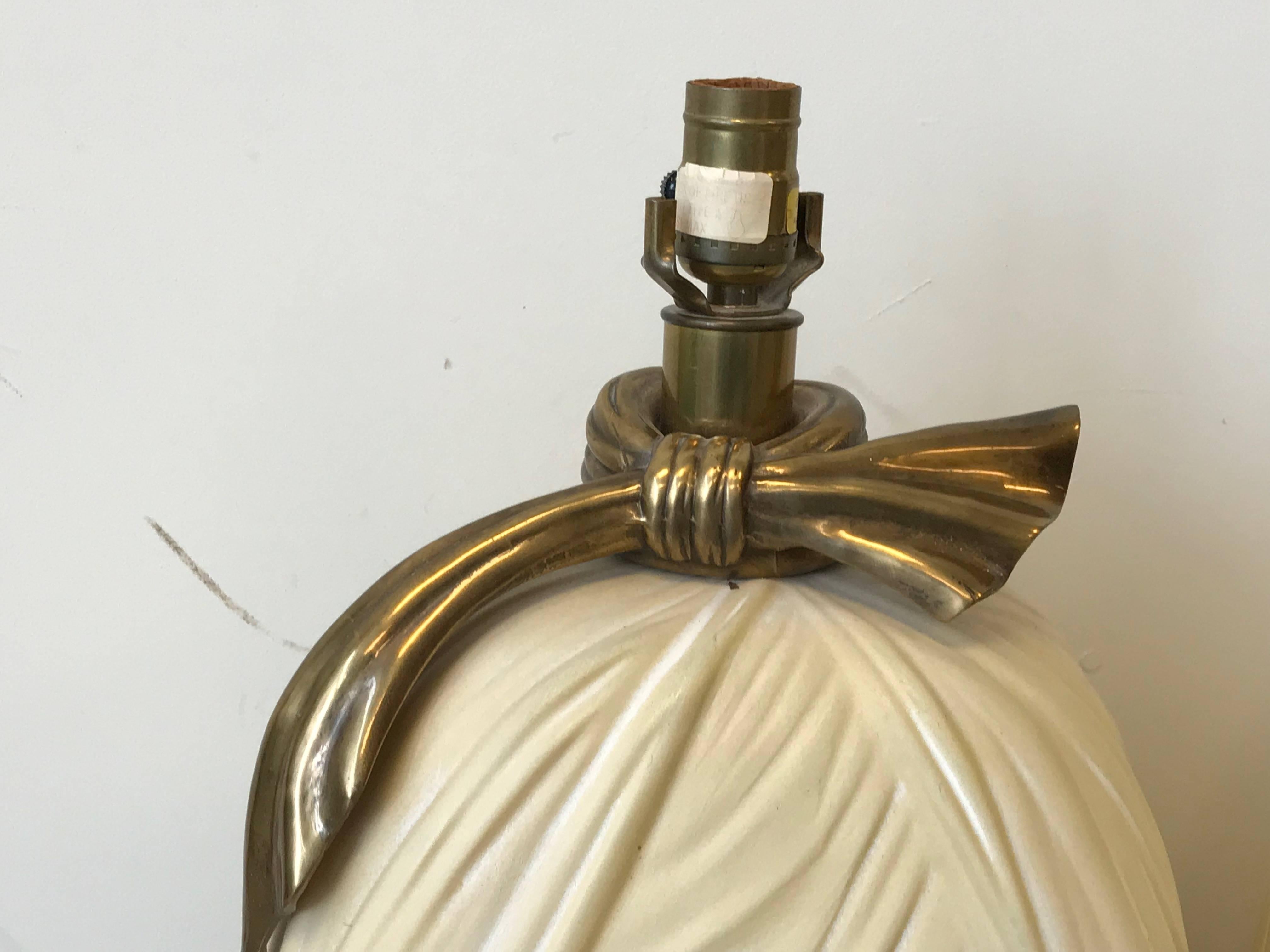 Offered is a fabulous, pair of 1980s Hollywood Regency Chapman lamps in the shape of draped bows. The base is ceramic, knotted bow is brass. Includes original labels.
