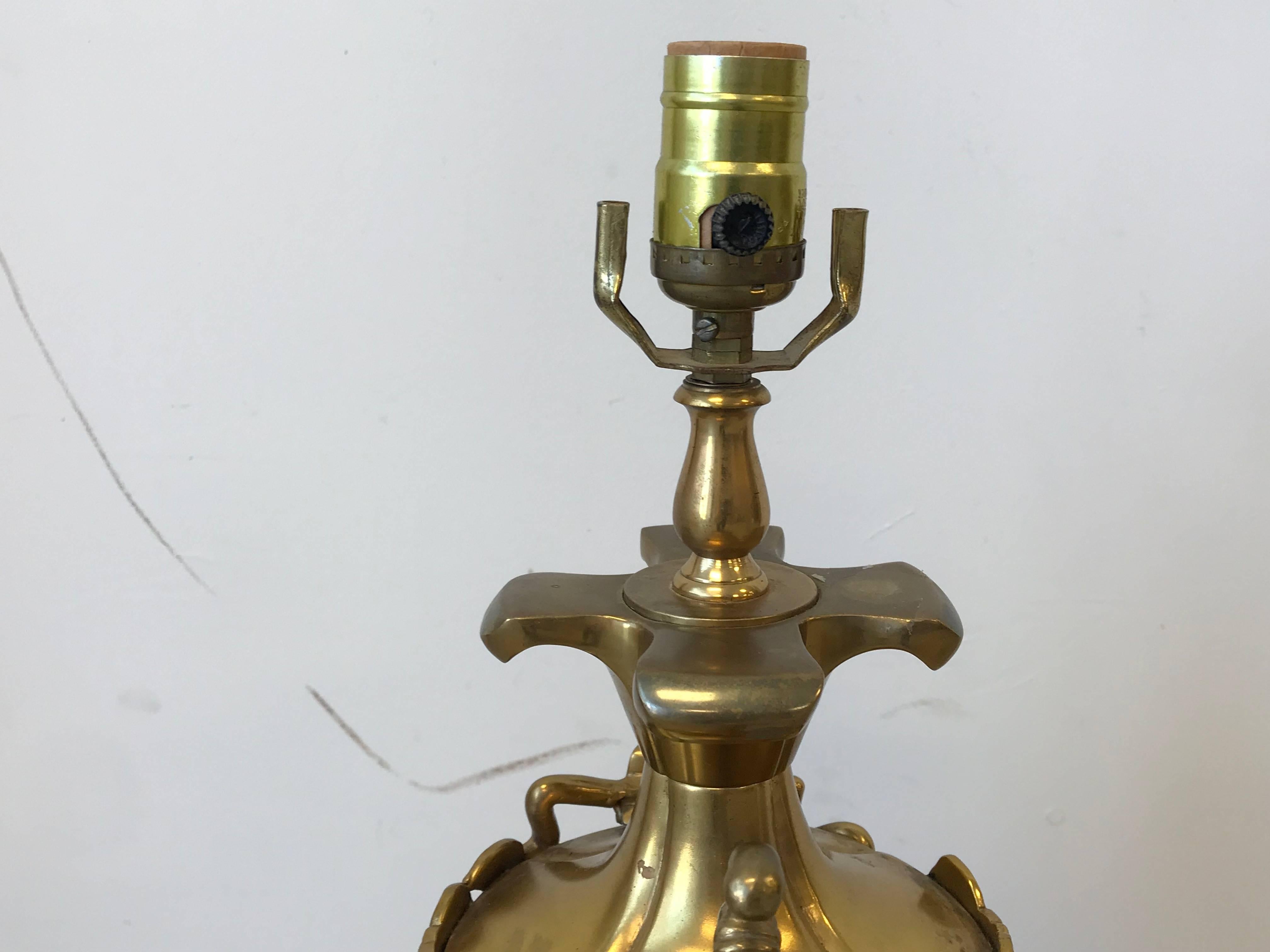 Offered is a stunning, 1960s, Italian brass Bacchus sculptural urn lamp. The brass urn piece is mounted on a decorative wood base. Heavy. Wired for standard US use.