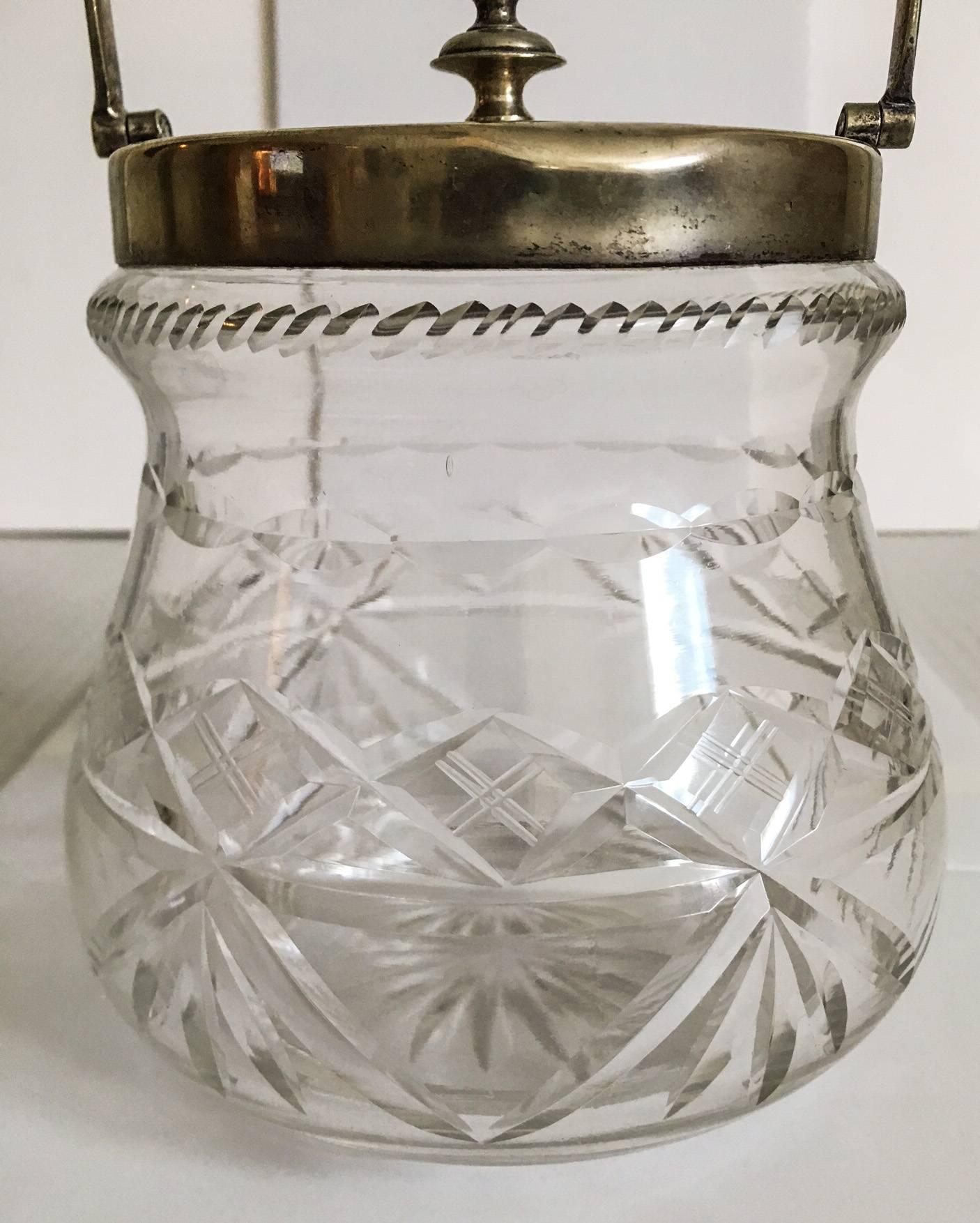 Wonderful deeply cut-glass biscuit jar with an electroplated nickel silver lid and handle by the English firm Slack and Barlow, 1930s. Marked EPNS with the S&B stamp inside a shield. Lid has a beautifully turned finial decoration. Note there is a