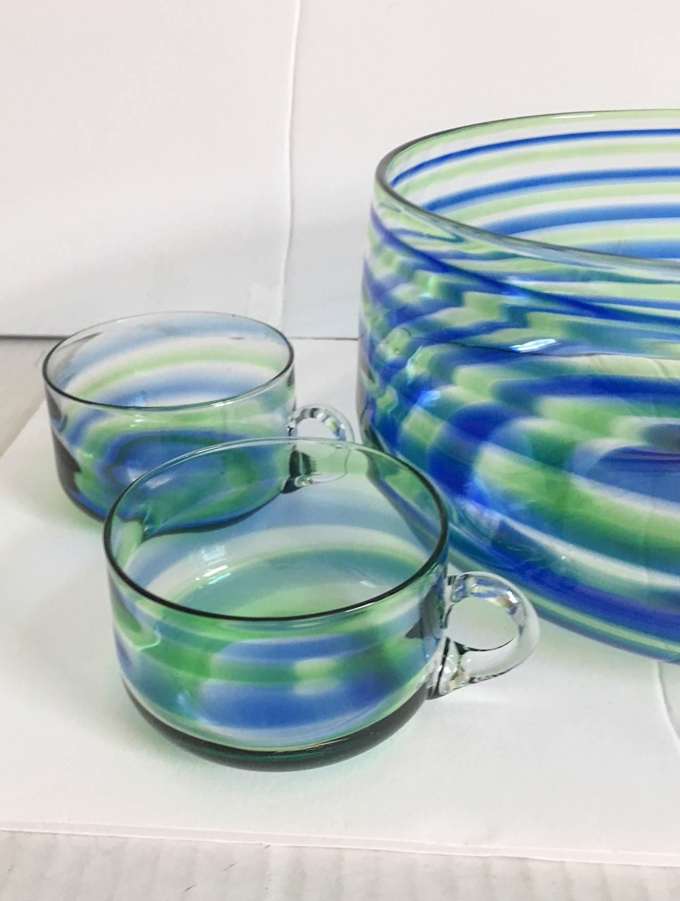 Wonderful blue, green, and clear swirled artisan glass punch bowl set with four handled cups. Bowl, 8.75