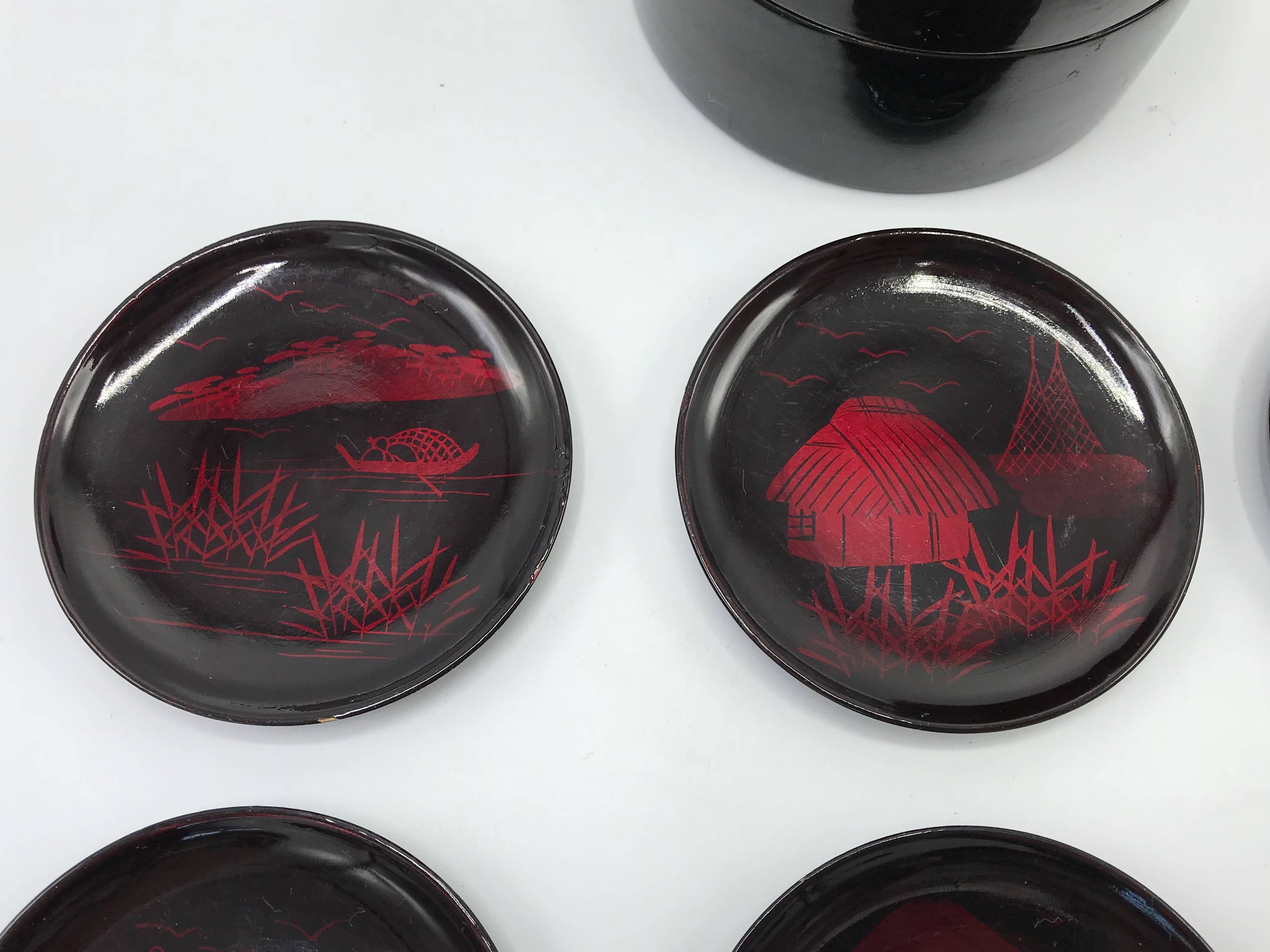Offered is a beautiful, set of seven, 1960s Japanese lacquered red and black coasters. The set includes; six coasters and one box. Each coaster has a different ornate pagoda scene. 

Box: 3.75