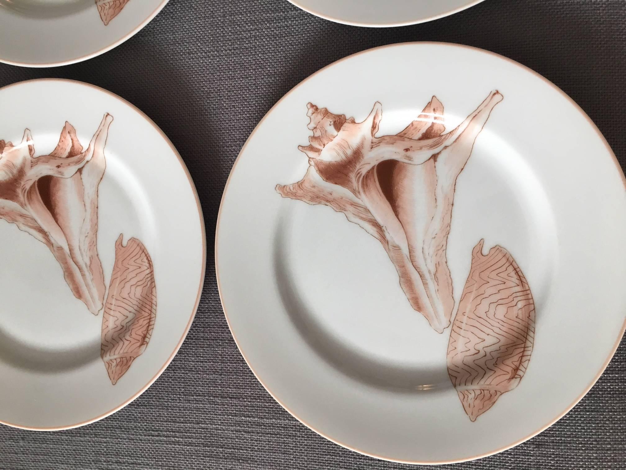 Wonderful set of four vintage 1976 salad plates by Fitz & Floyd in the Coquille pattern decorated with pale pink conch seashells on a white ground. Each measures 7.5" round x 1.25" height.