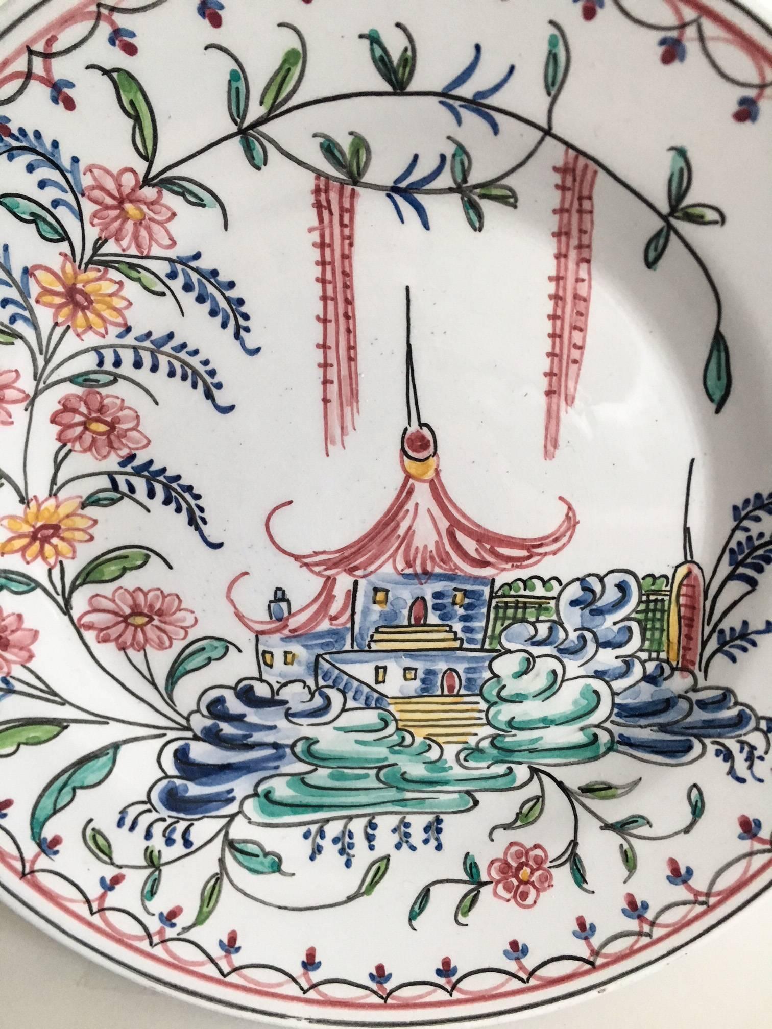 Delicately painted stoneware plate made by Mottahedeh depicting a pagoda ensconced in traditional Chinoiserie flowers and clouds. Plate is from the Birmingham Museum of Art in Alabama, circa 1950s-1960s. Original Mottahedeh paper label intact; made