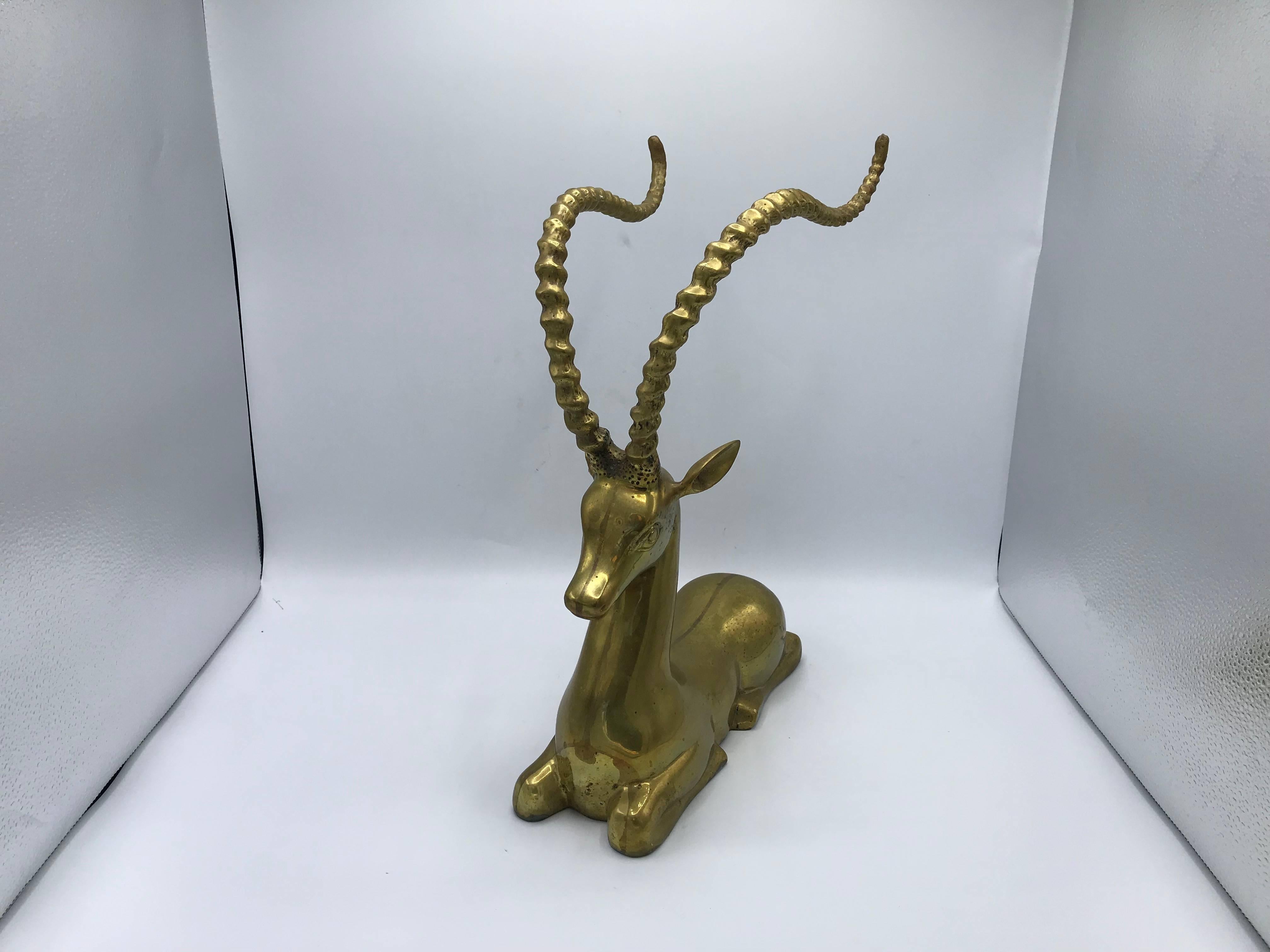 Listed is a gorgeous, 1960s Italian Sarreid Ltd. brass gazelle sculpture. The exaggerated horns give a modern-glam twist, on the seated sculpture. Incredibly heavy, weighing 12lbs.