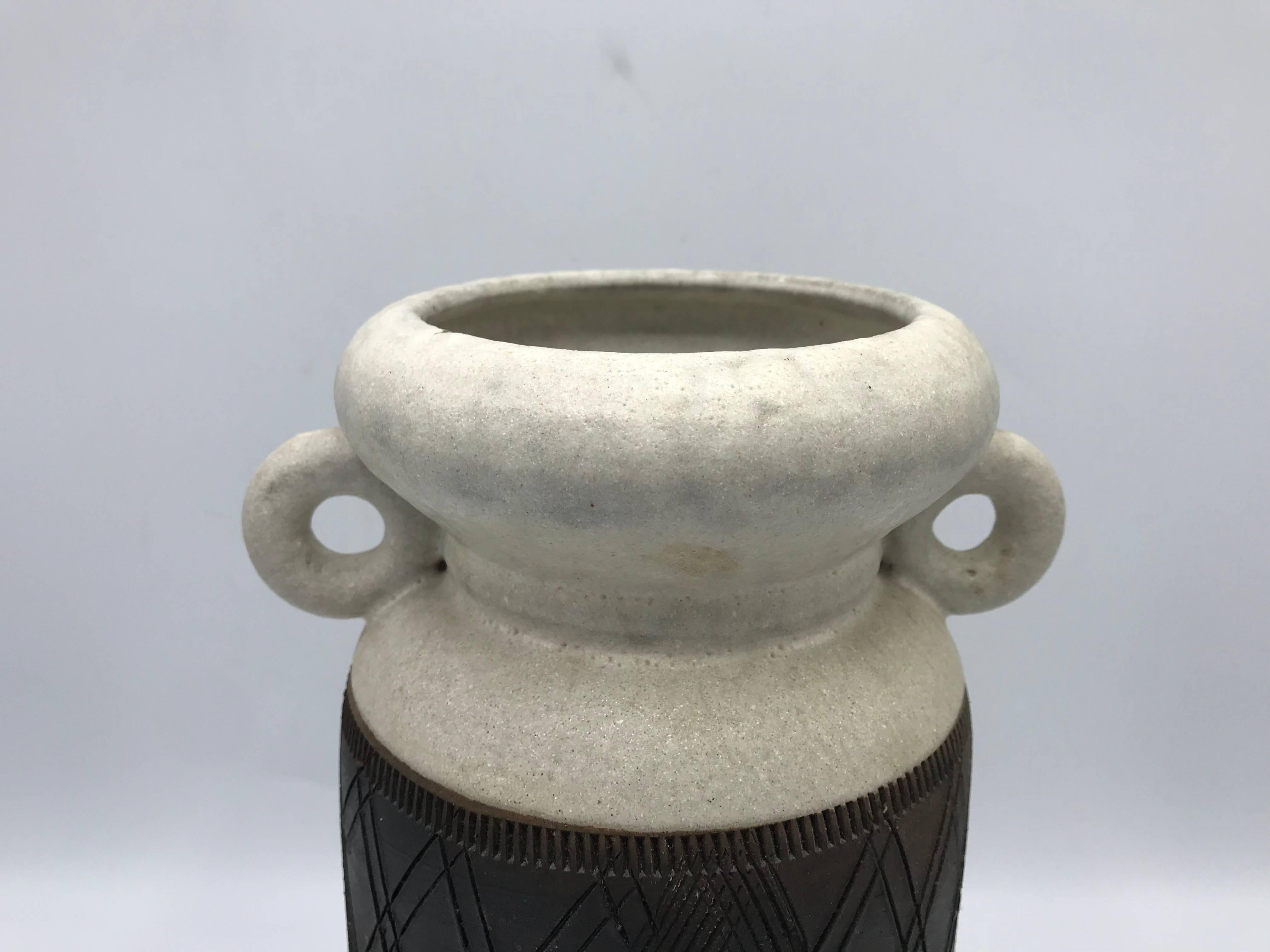 Offered is a gorgeous, 1960s Italian Bitossi pottery vase. The piece has circular handles and a beautiful, geometric plaid motif. Marked on underside, with original paper label.
