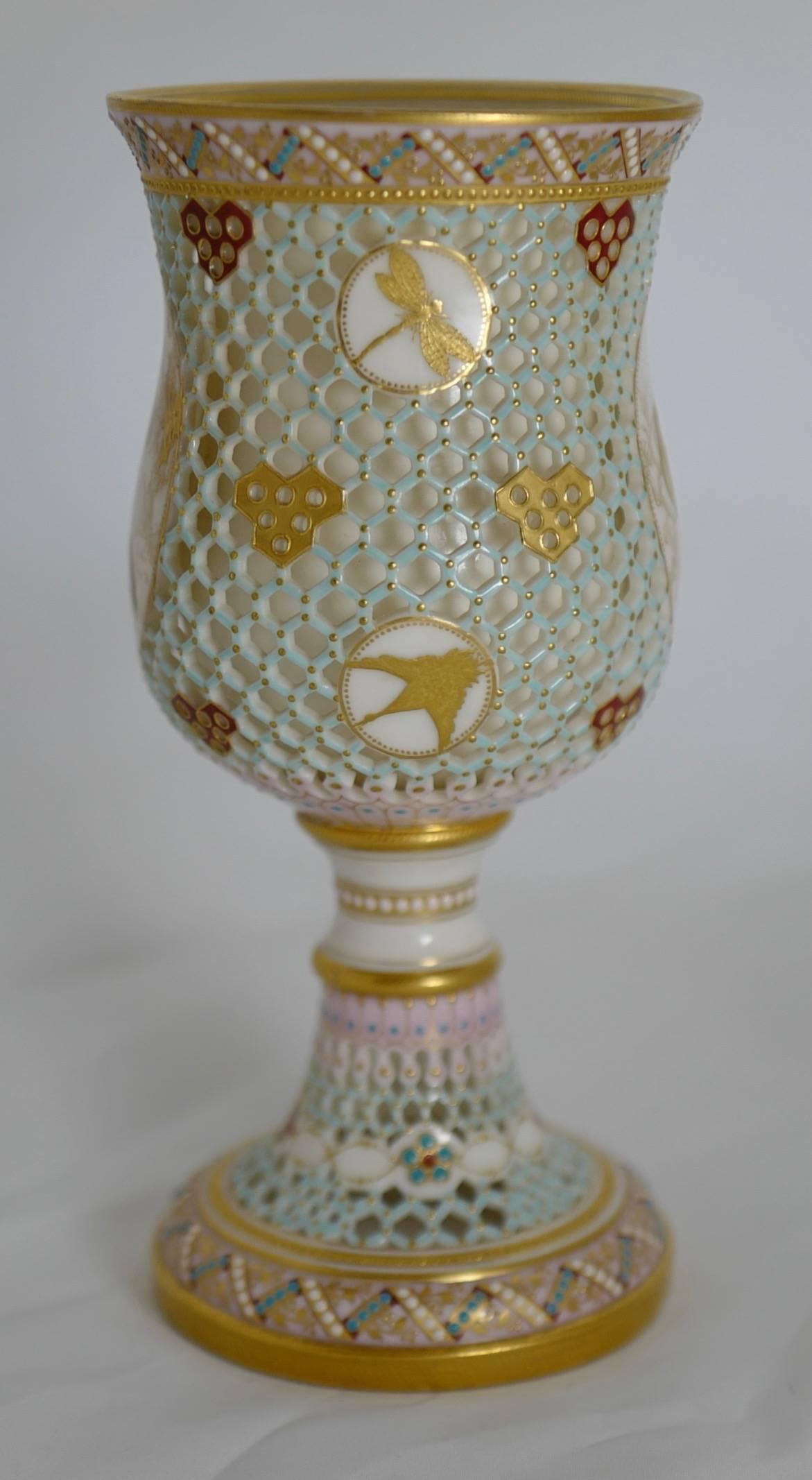 This exquisite goblet, probably by George Owen (also known as the greatest of all reticulators) is designed with an entirely pierced body and stem in a pale-blue honeycomb pattern dotted with gold between borders of zig-zagging turquoise and white