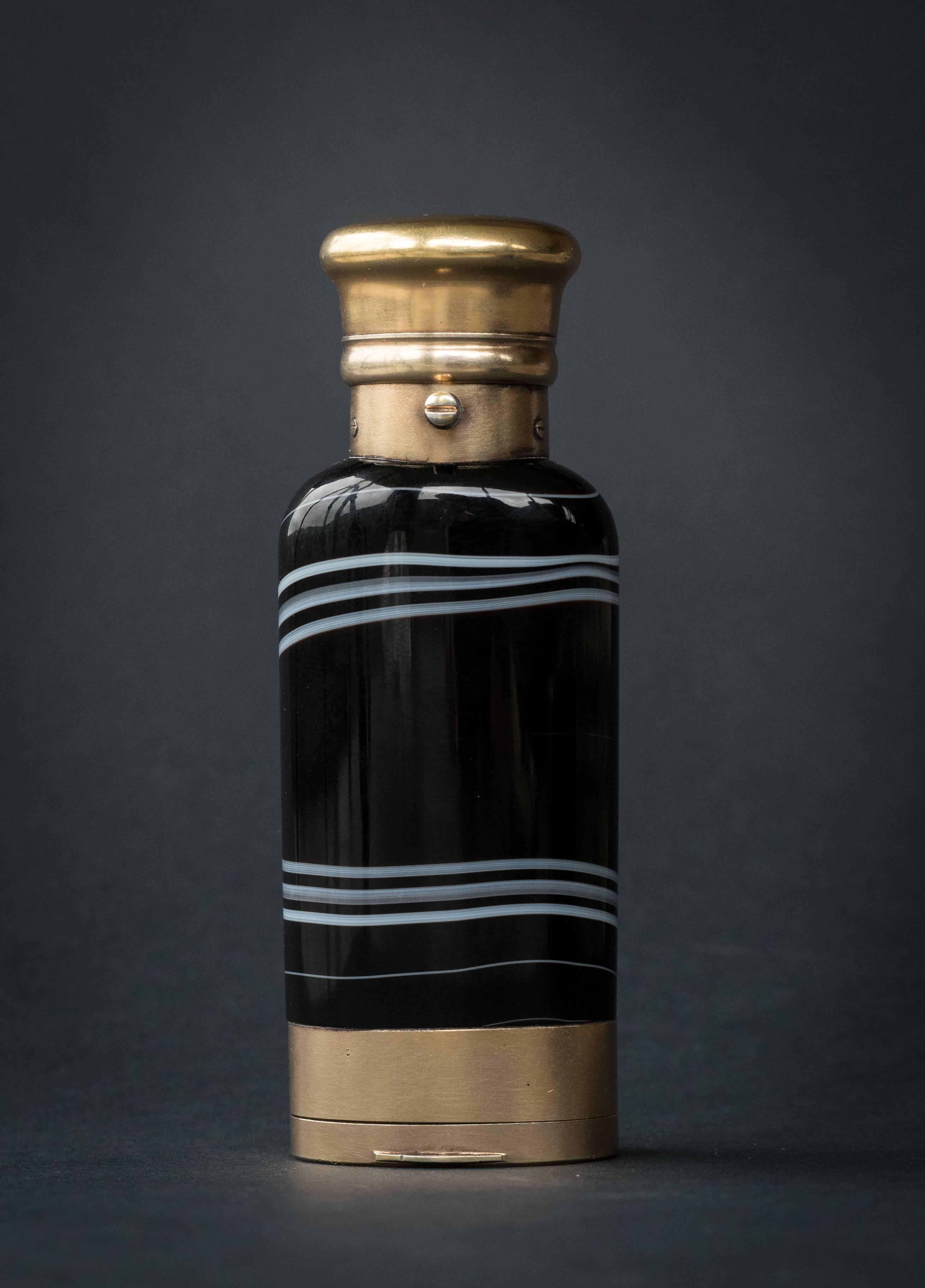 Sampson Mordan made a large number of very special objects for the leading Bond Street retailer of the day William Thornhill.
 
This Banded Agate scent bottle with vinaigrette to the other end set in frosted gilt mounts is contained within its
