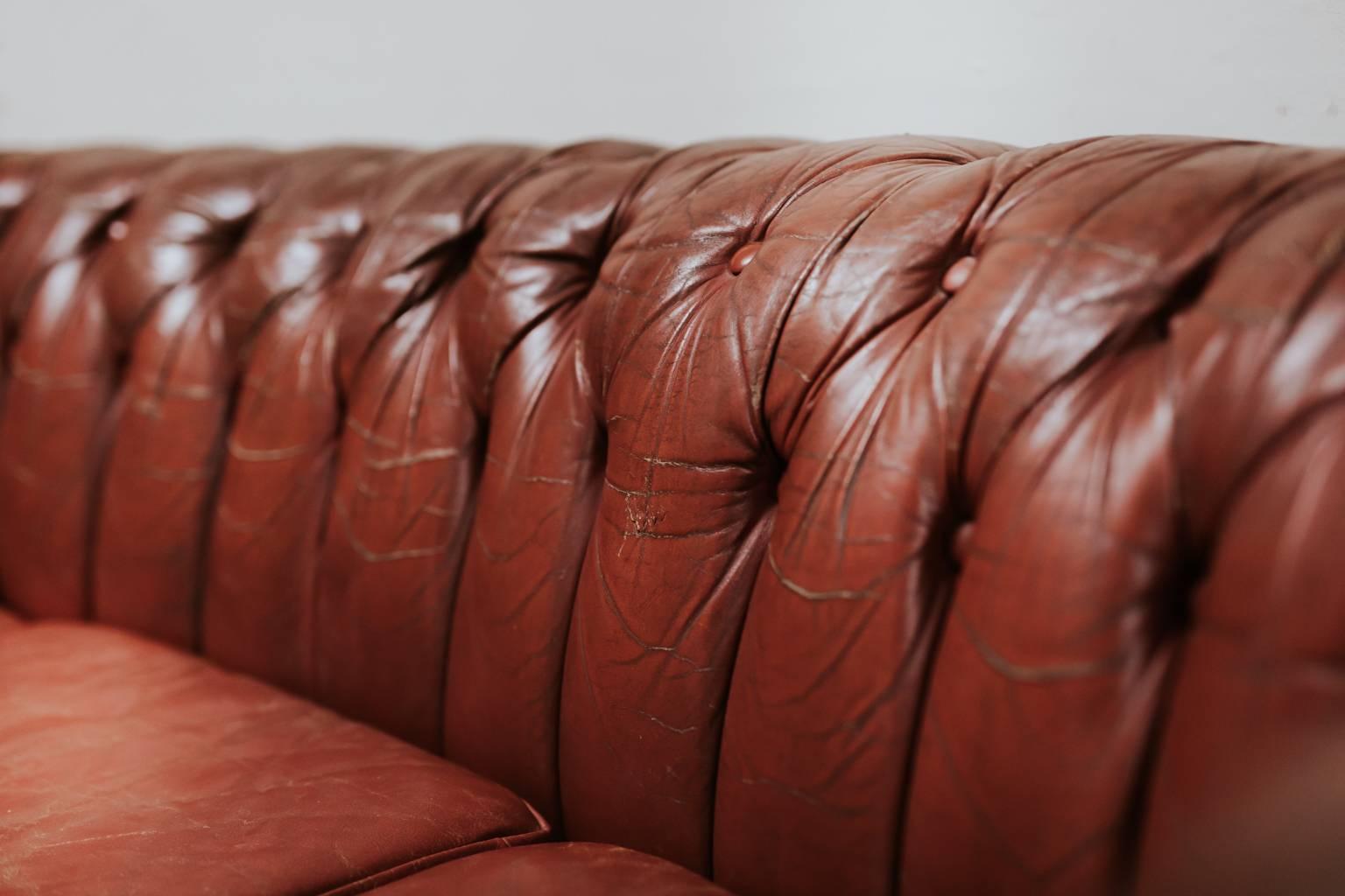It is all about the crescent moon shape of this chesterfield, great patina on the red leather as well.