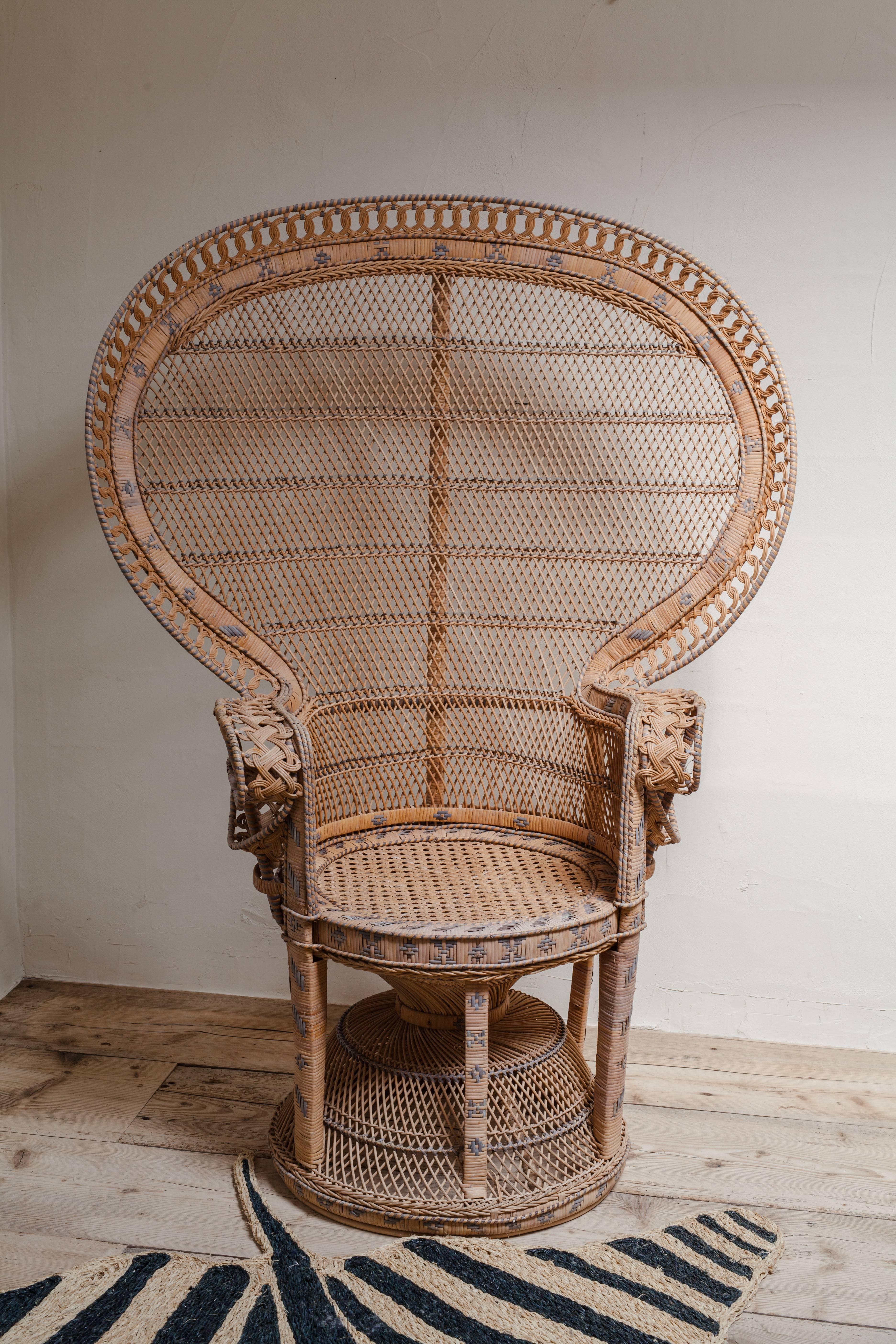 An iconic 1970s wicker/rattan peacock chair, also called the Emanuelle chair.

 