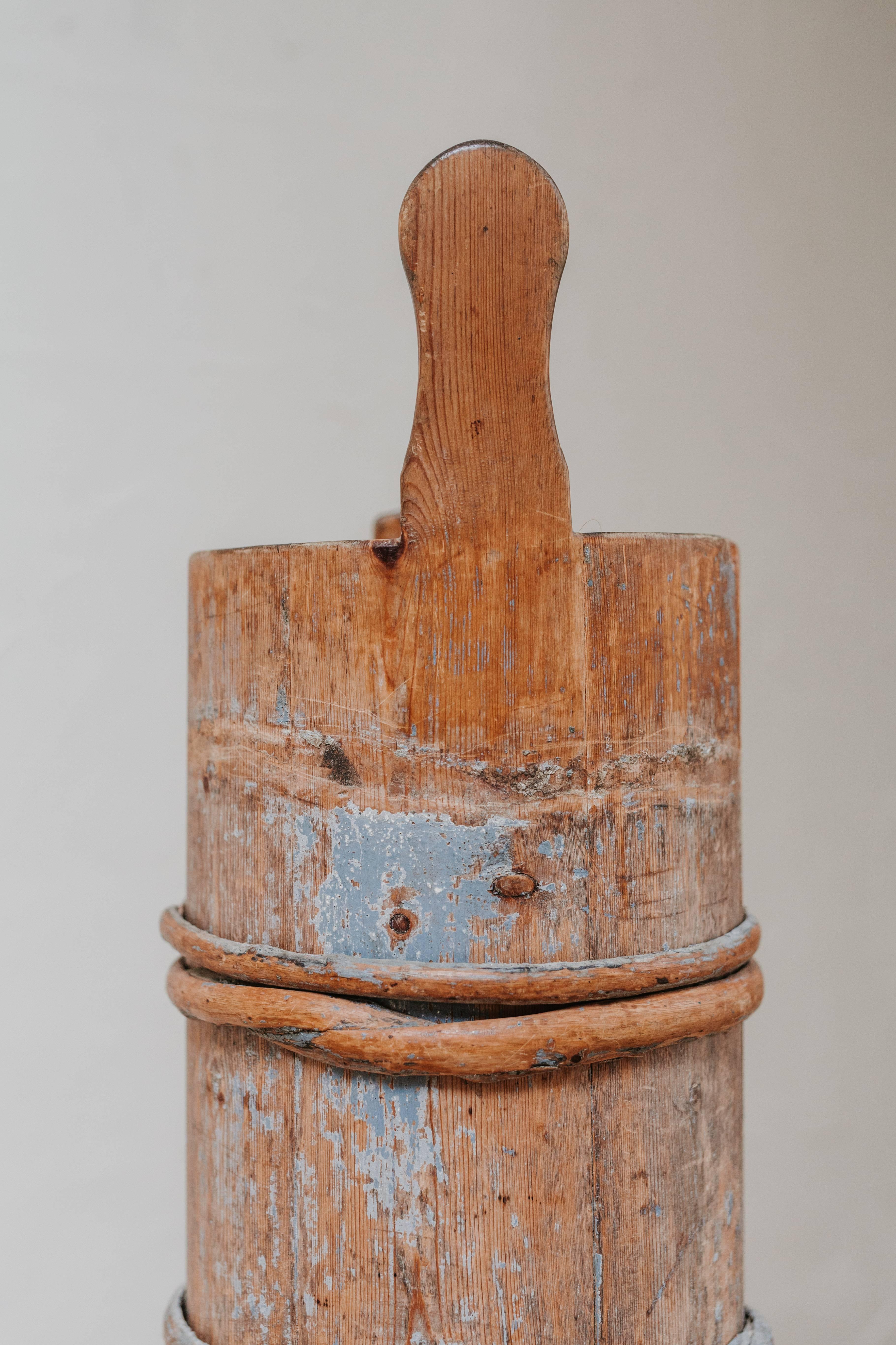 this is a 19th century, Swedish buttermaker, with rests of old blue paint, here used as a cane/umbrellastand.