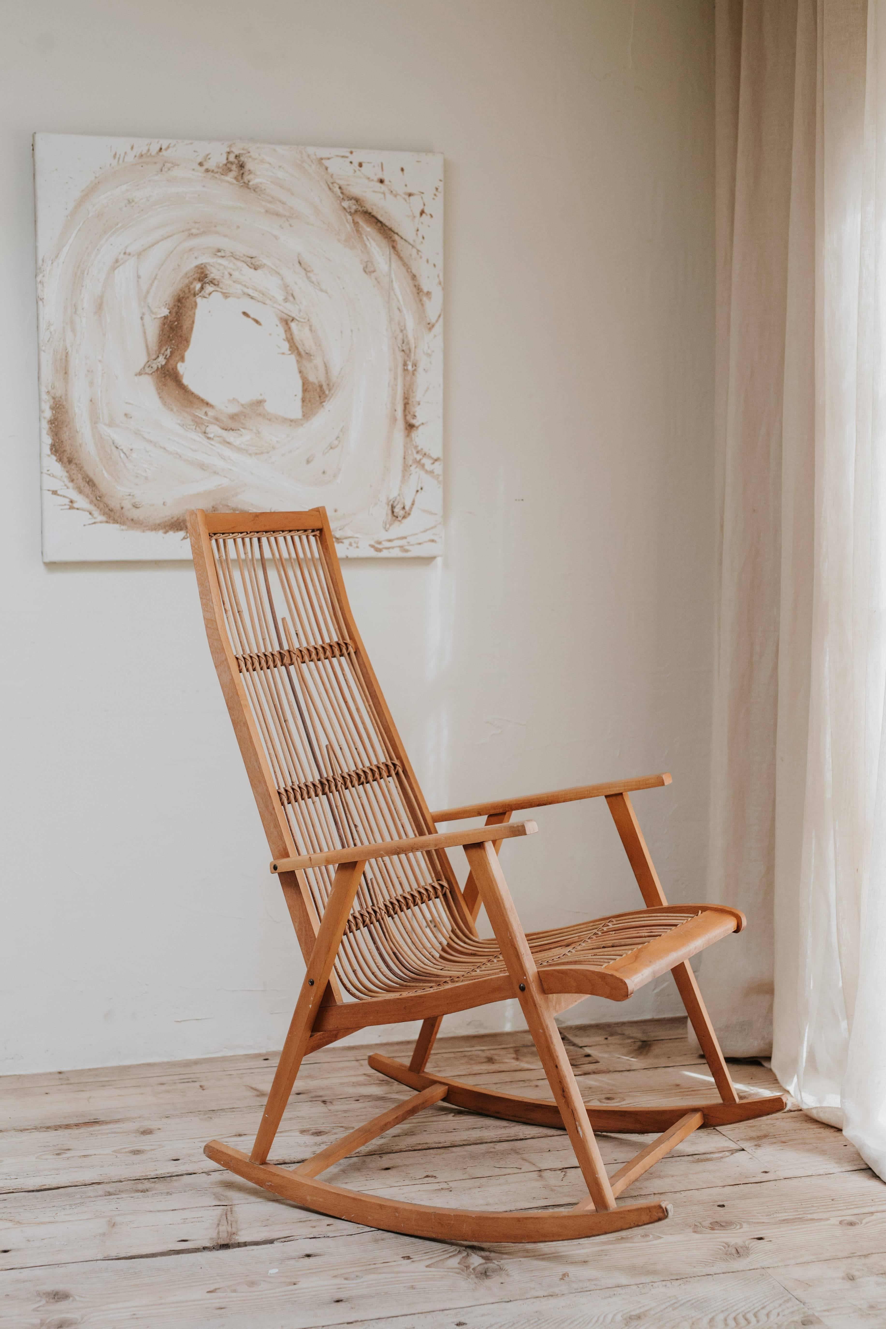This is a very smart wood and rattan vintage rocking chair, made during the 1960s in Germany.