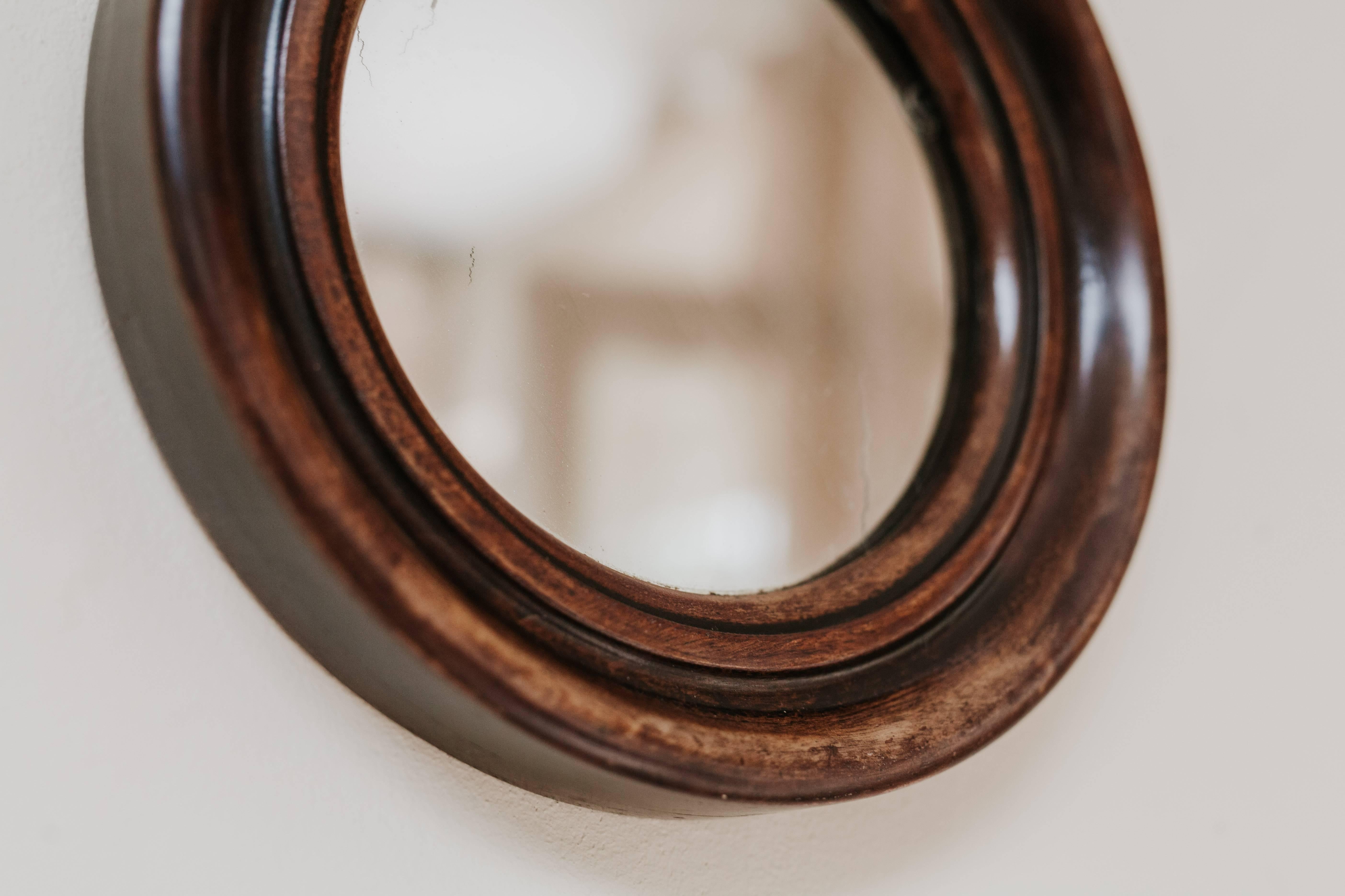 This is a 19th century circular mahogany framed mirror, wonderful patina.