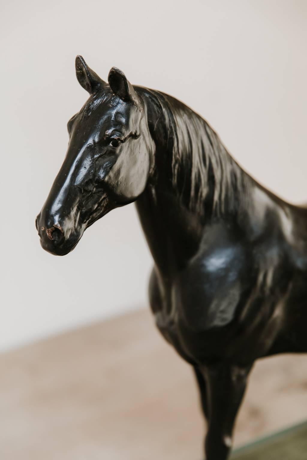 This is a plaster statue of a horse, mounted on wooden base, elegant and strong, wonderful object for every horse lover.