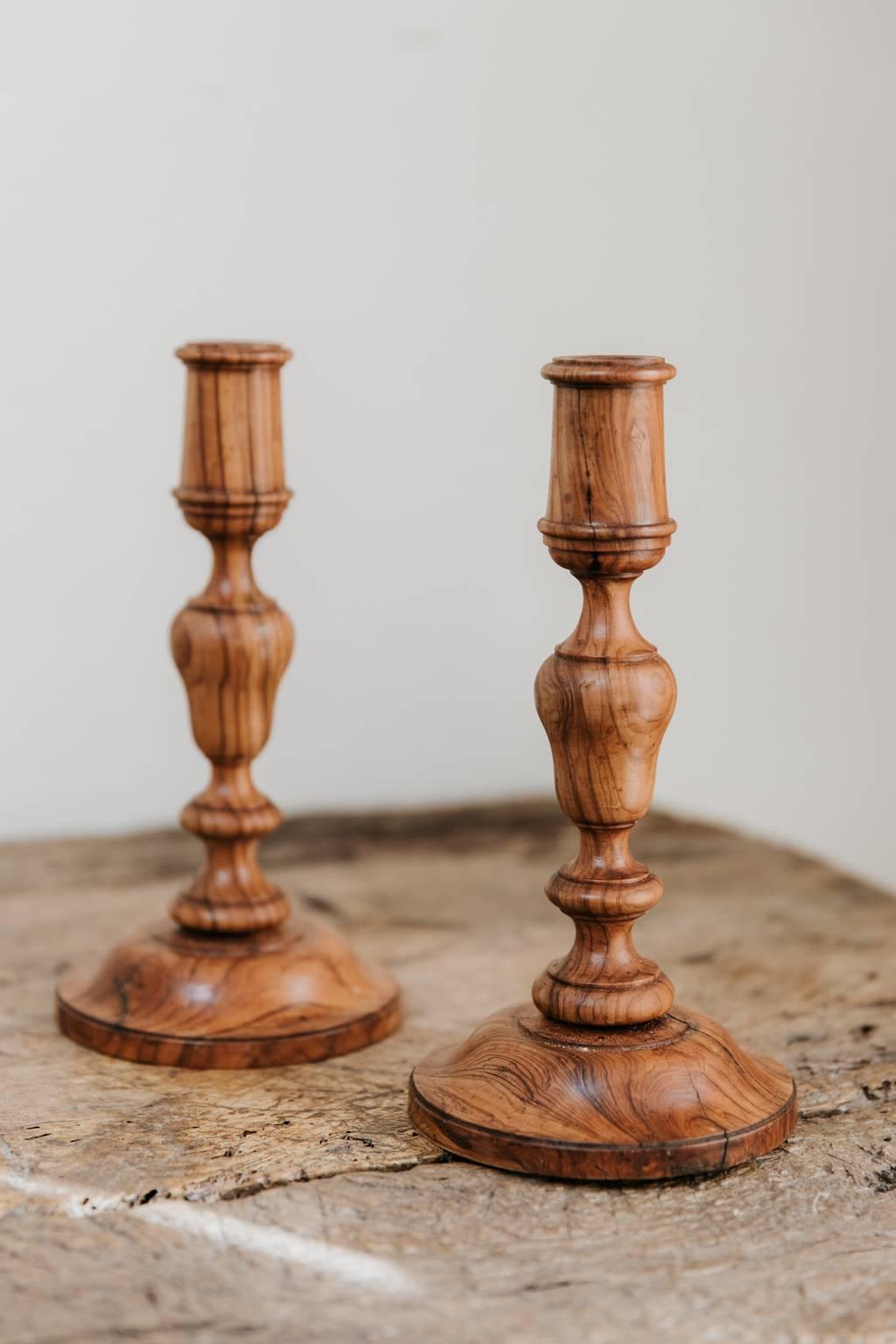 This elegant and smart pair of candlesticks were made in the 19th century in France, latheturned in olivewood, filled with lead to make them stand stabile on every table.