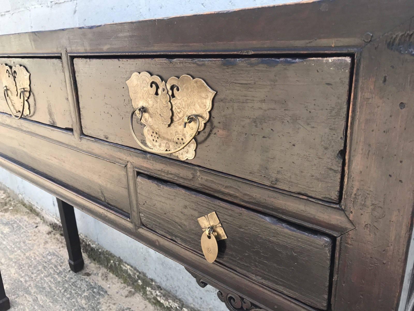 Here we have a fantastic elm, Chinese altar or console table from the Fujian province in eastern china. It's made from Elm fitted with three drawers with engraved handle plates, over a further two drawers. Dated from 1860s. A rare piece to