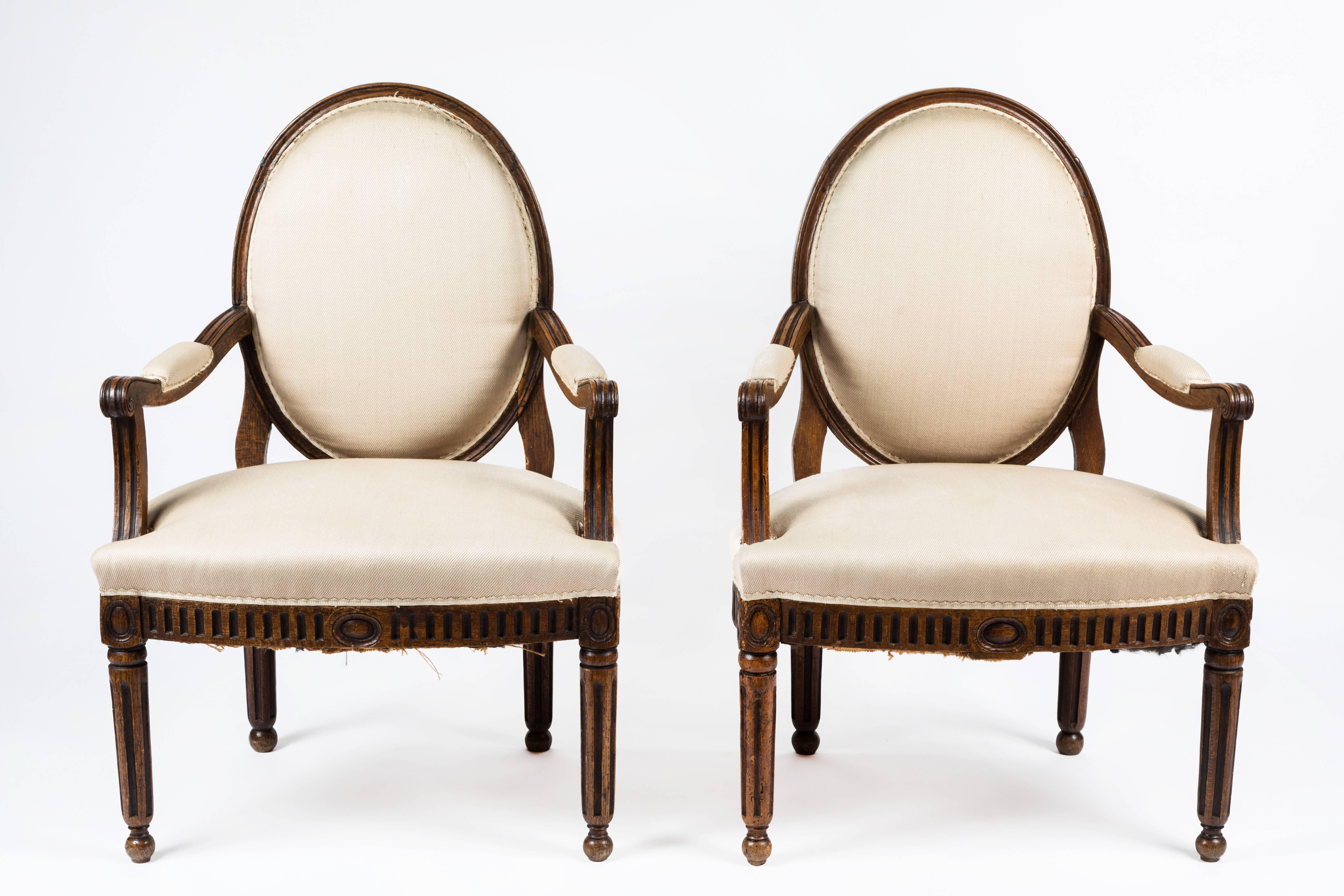 Pair of antique 17th century neoclassical style armchairs with original walnut finish (restored condition). Inside back, seat and arms upholstered with Clarence House woven fabric.