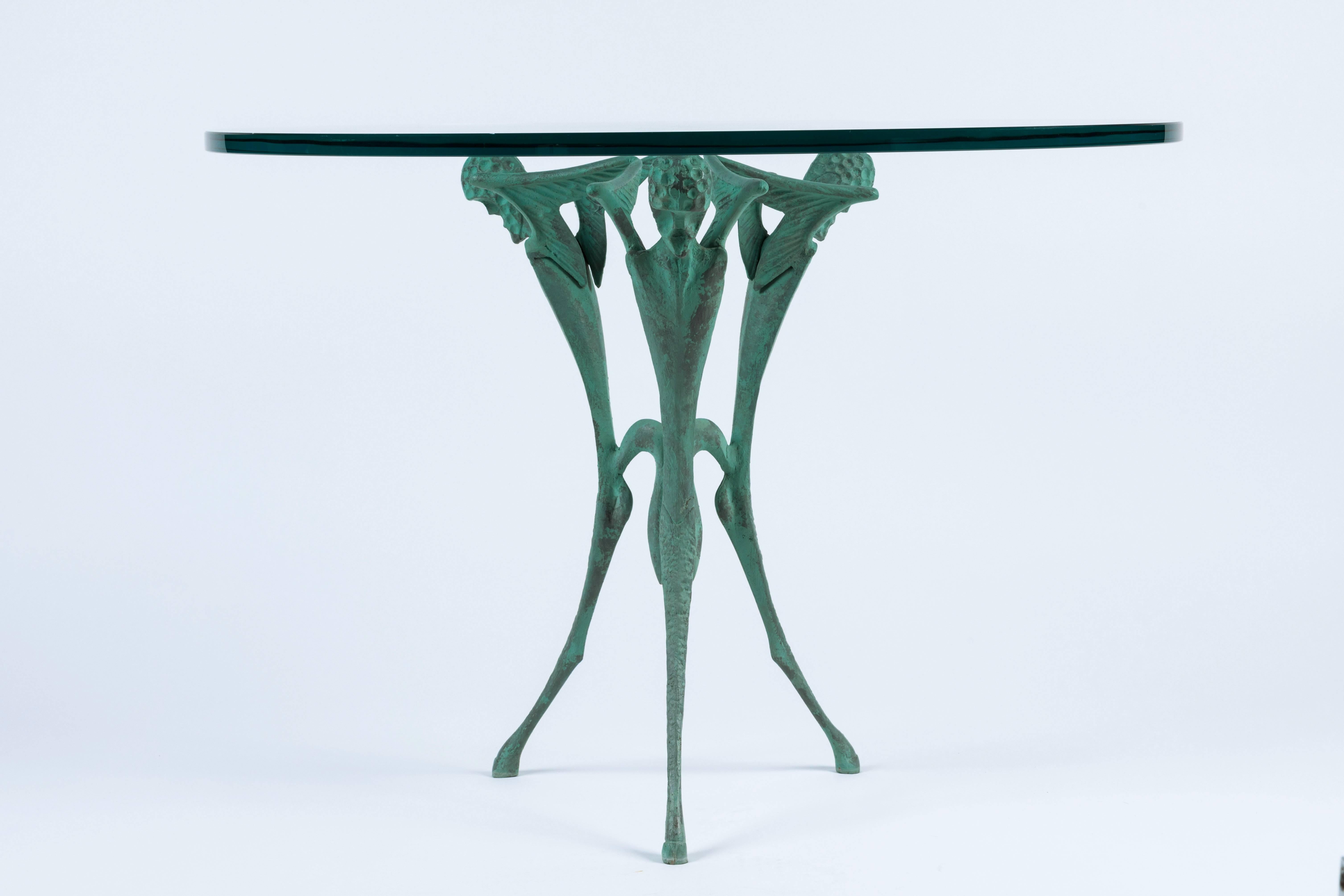 Three-leg satyr table by Dan Johnson. Bronze base with new glass top, inspired by images of Greco-Roman mythological figures.