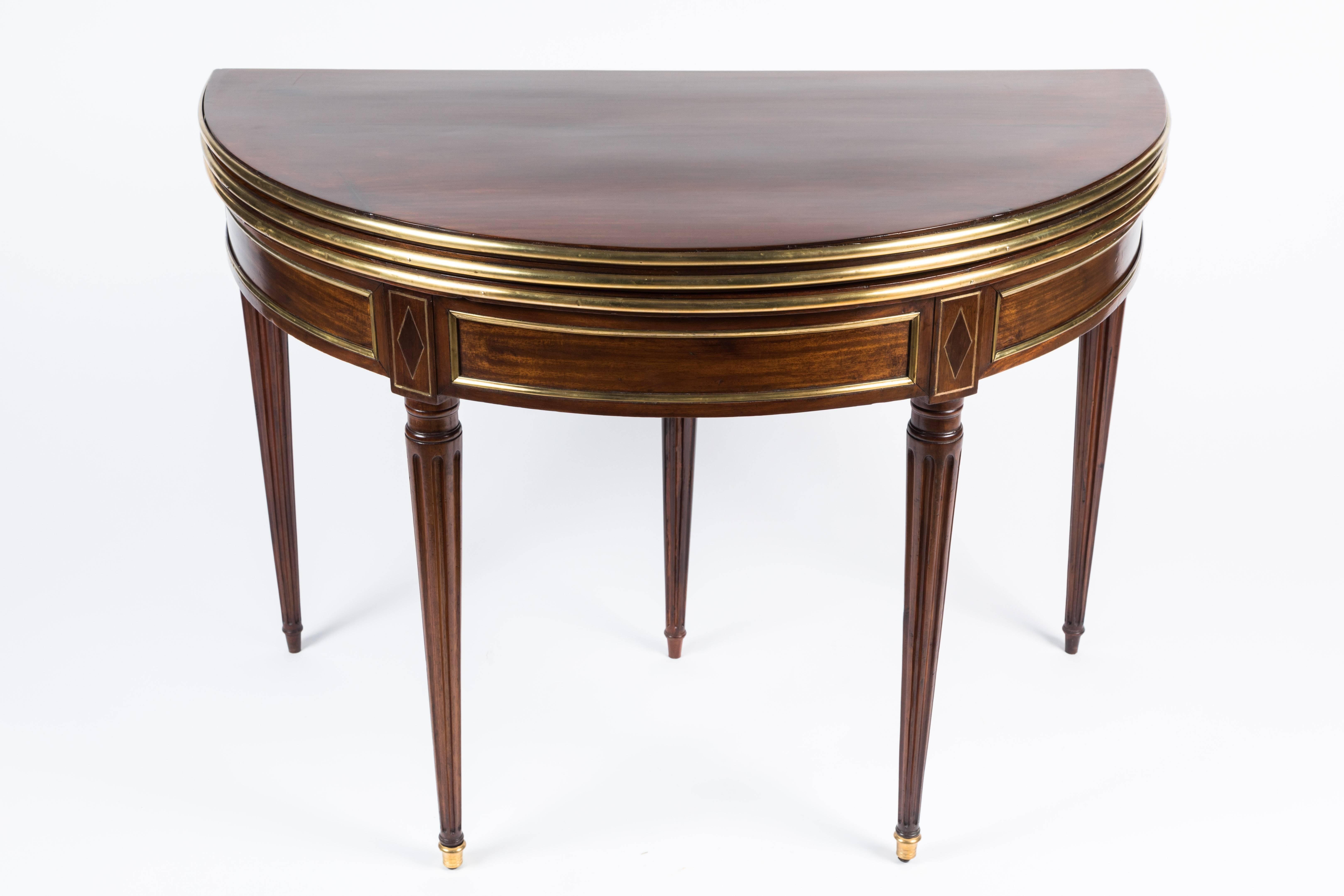 Newly restored French 18th century Louis XVI flip-top demilune console table in mahogany, with ormolu mounts and gilt inlay. Flips open to reveal new purple felt.