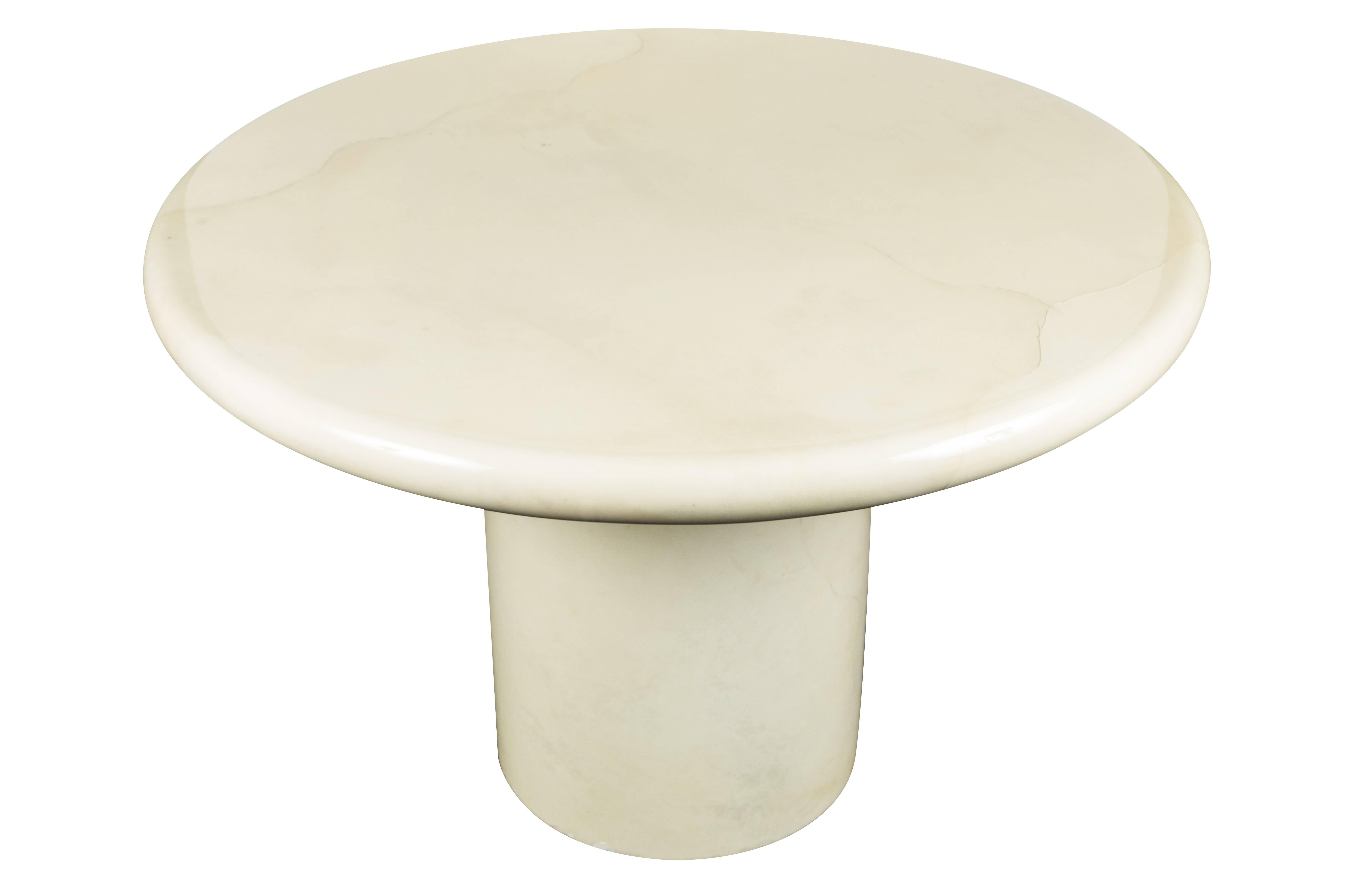 Round, sculptural, center or dining table by Karl Springer. Clad in Ivory colored goatskin, with high gloss lacquer finish.