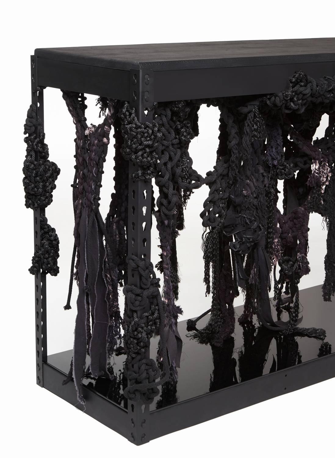 A collaboration between Oliver M. Furth and Tanya Aguiniga, 'Kelp Forest' features two unique consoles of reclaimed woven fibers, negotiating a matte black nickel-plated industrial framework. 'Kelp Forest' serves as a catalyst to push the weaving