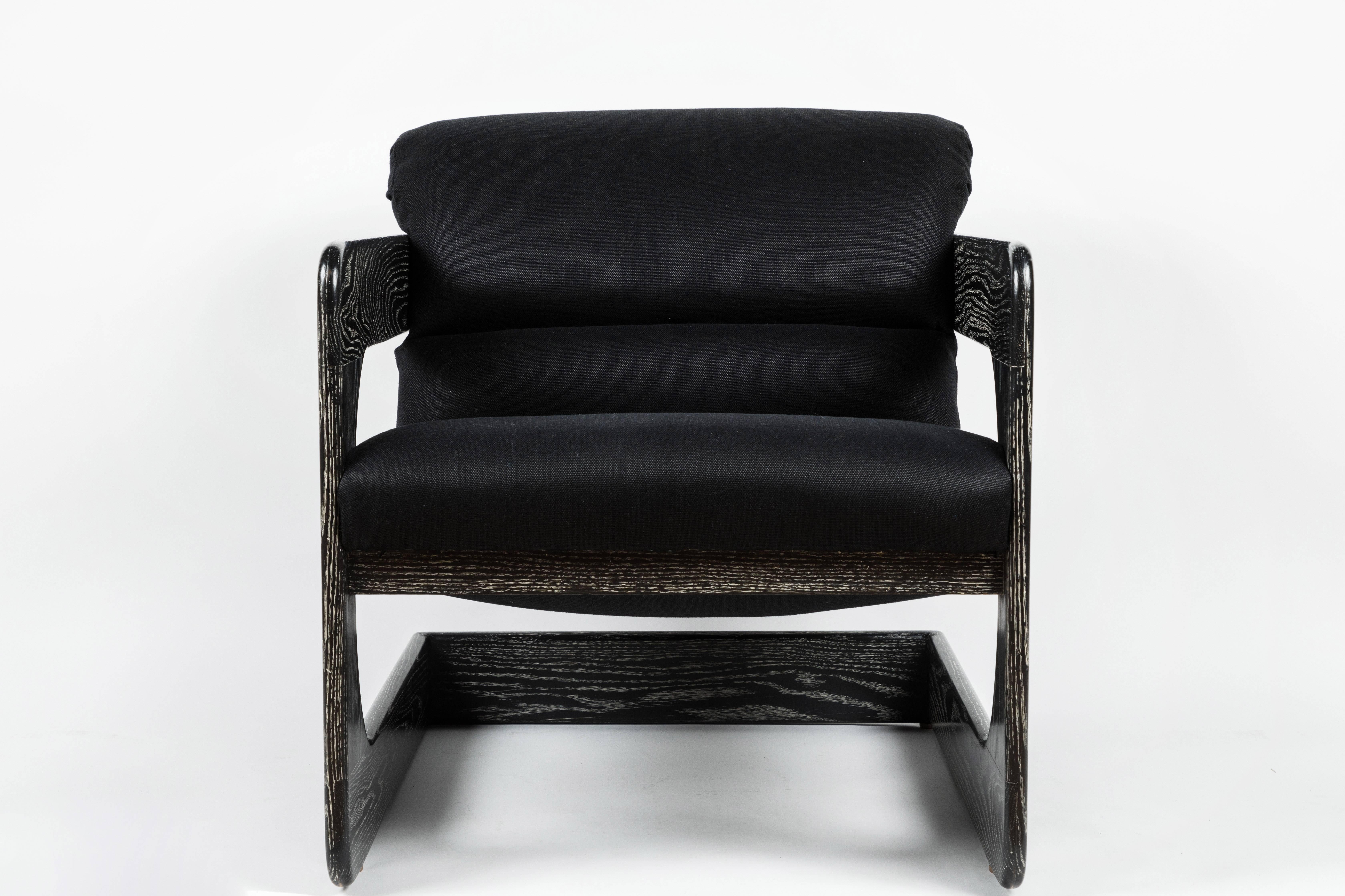 Rare lounge chair designed by Lou Hodges for California Design Group in the 1970s. Cantilever design oak frame features trademark rounded edges. Restored in striking black ceruse finish and newly reupholstered in black linen fabric. Iconic piece of