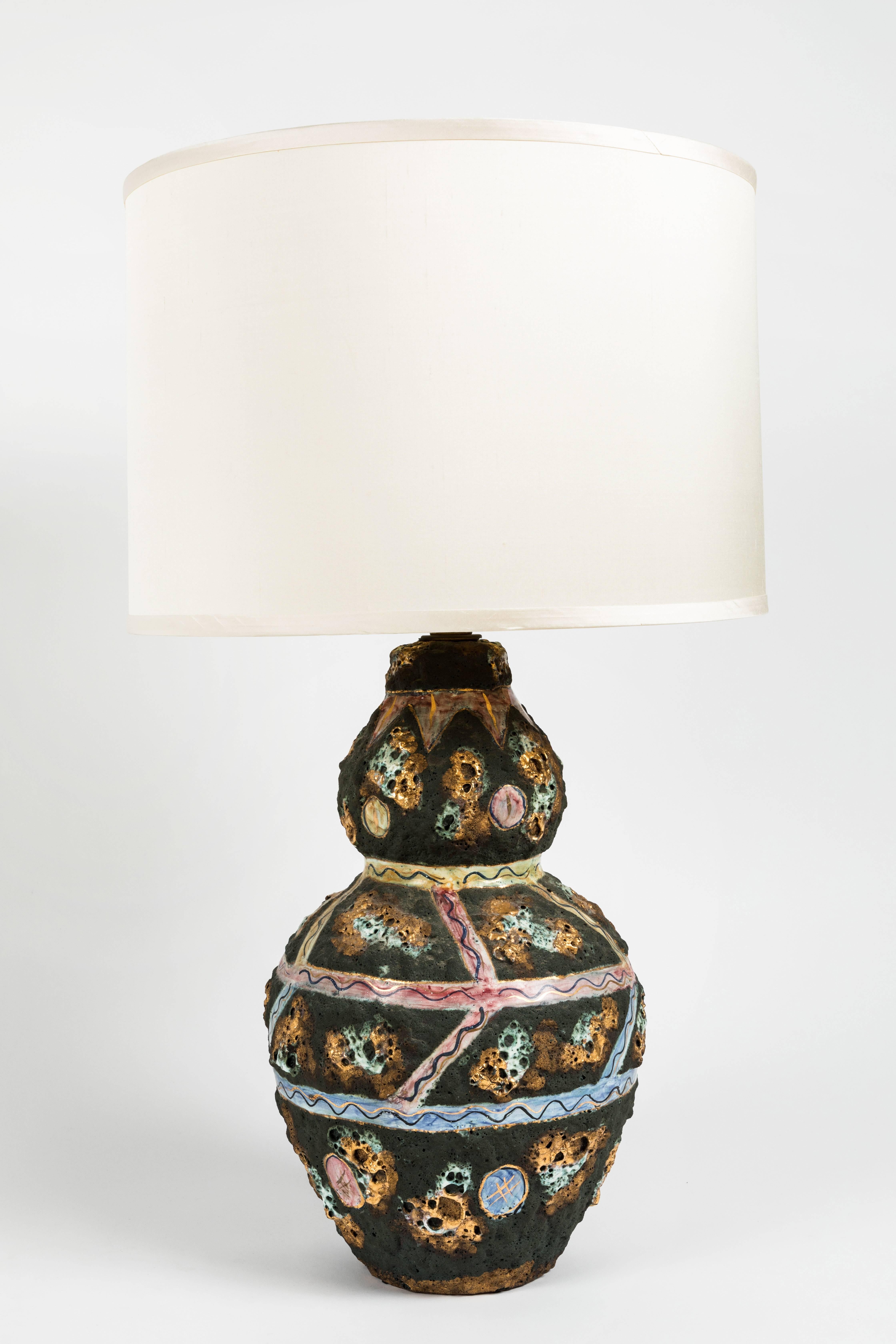 Pair of ceramic table lamps in the Brutalist style. Double-gourd shape with multicolored glaze. Recently rewired with new ivory silk shades, Italian, mid-20th century.