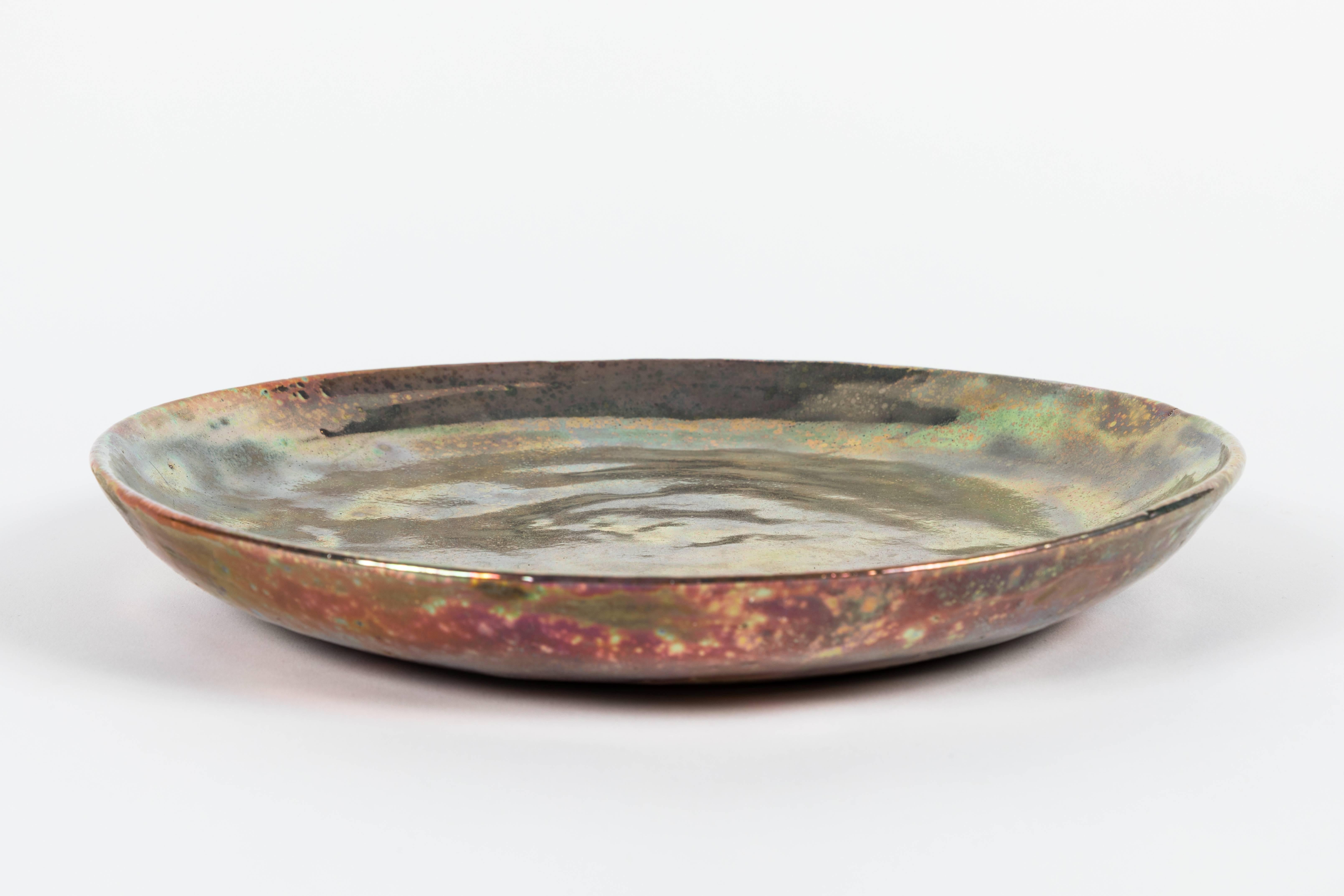 Ceramic earthenware charger by Ojai, California ceramicist Beatrice Wood (1893-1998), in her signature iridescent glaze. Signed 